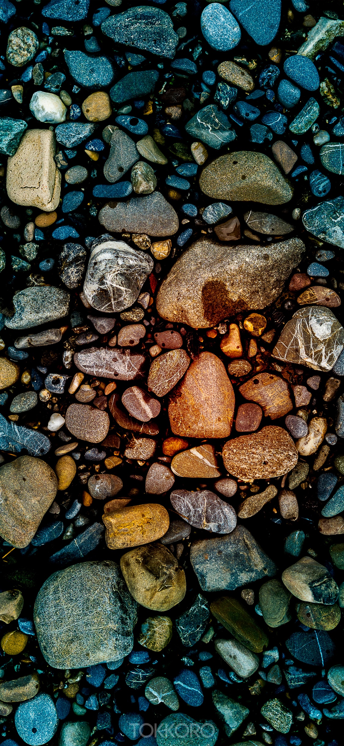 Close-up of colorful wet stones on a dark surface HD Phone Wallpaper