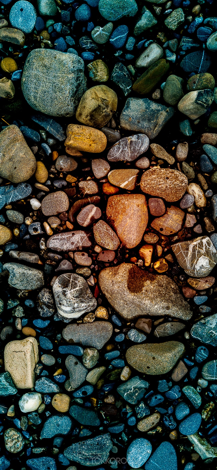 Close-up of colorful wet stones on a dark surface HD Phone Wallpaper