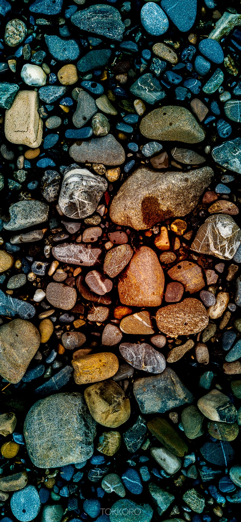 Close-up of colorful wet stones on a dark surface HD Phone Wallpaper