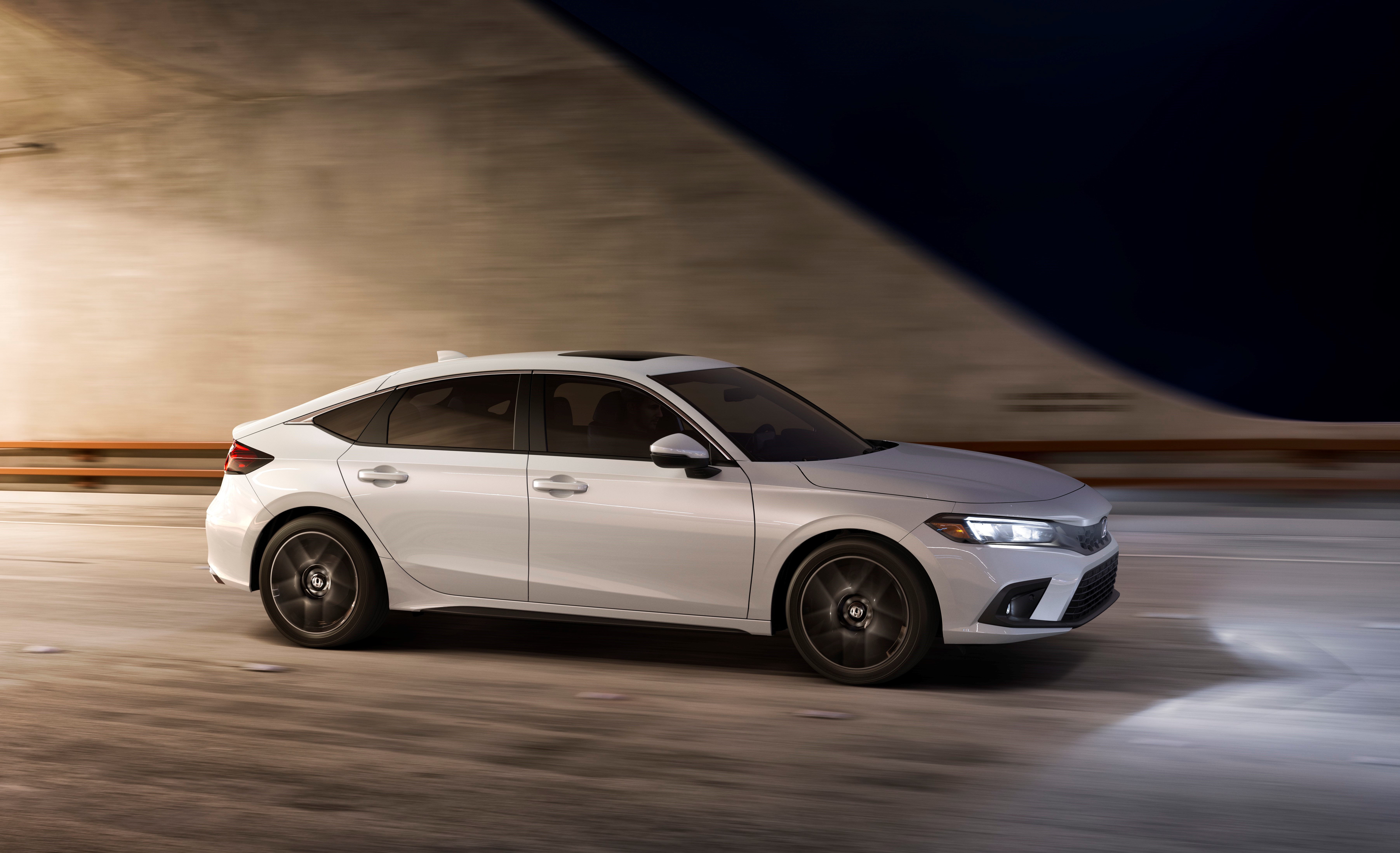 2022 Honda Civic Hatchback Sport Touring driving at night HD Wallpaper