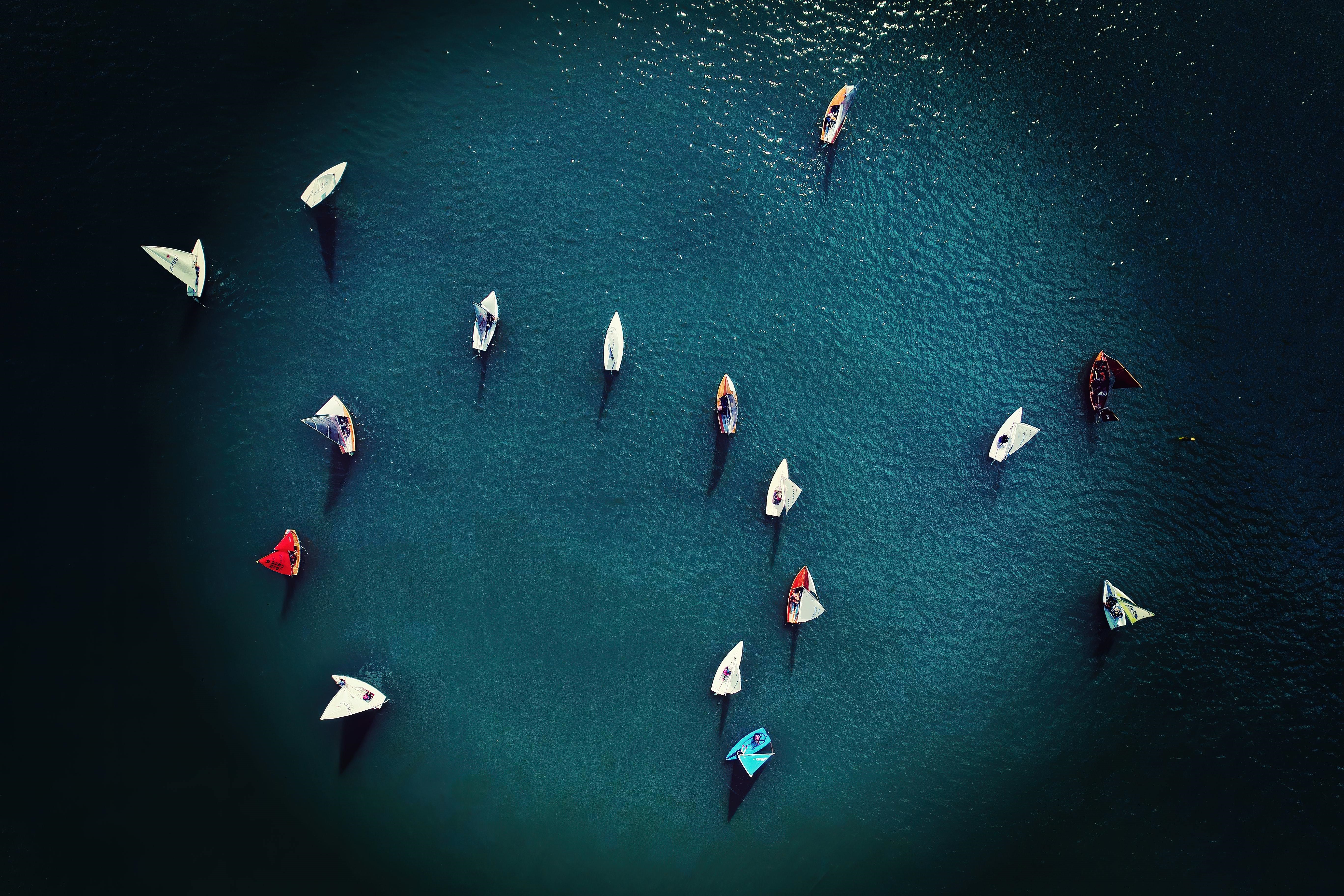 Sailboats racing on blue water, aerial view HD Wallpaper