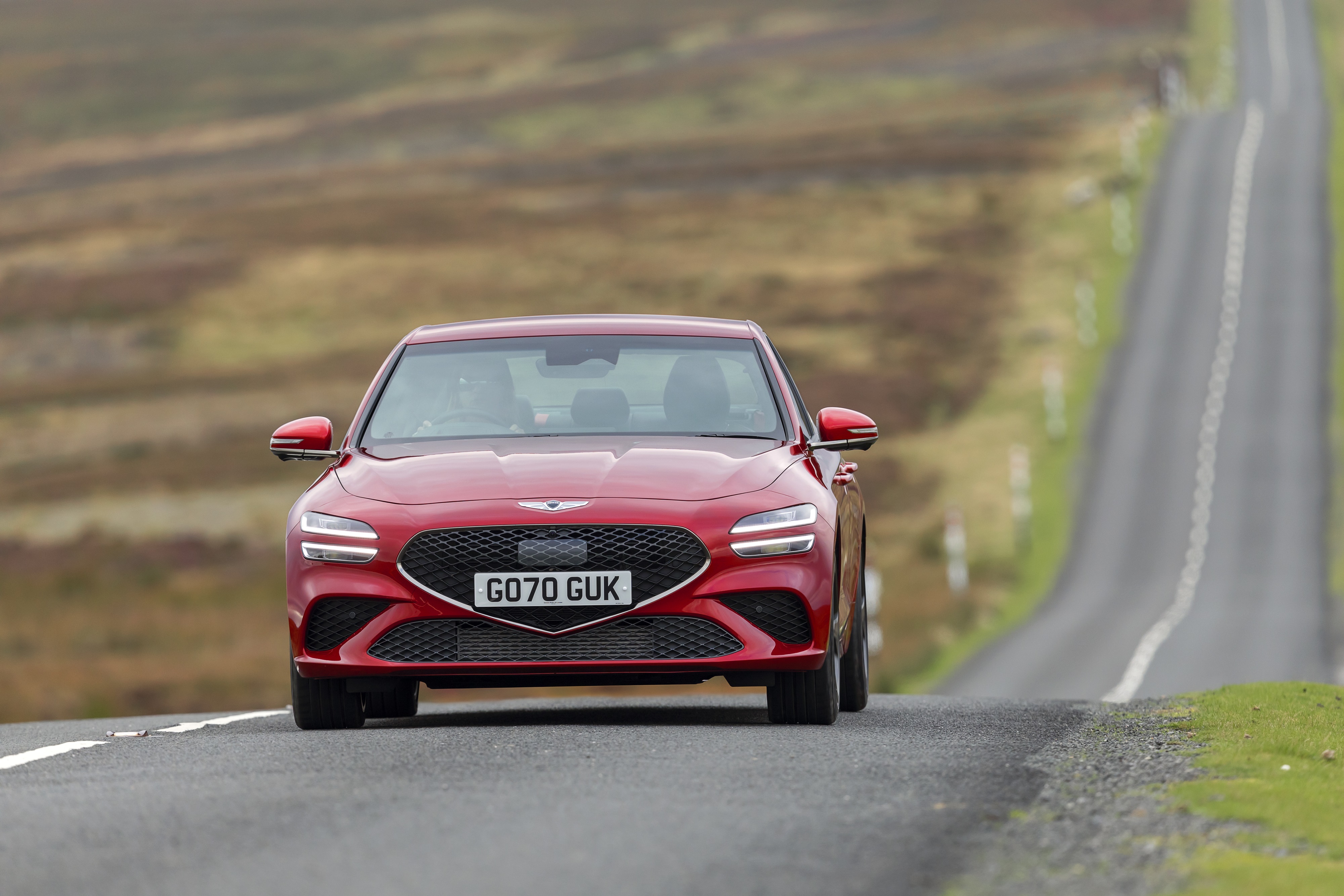 Red Genesis G70 2.0T driving on a road HD Wallpaper