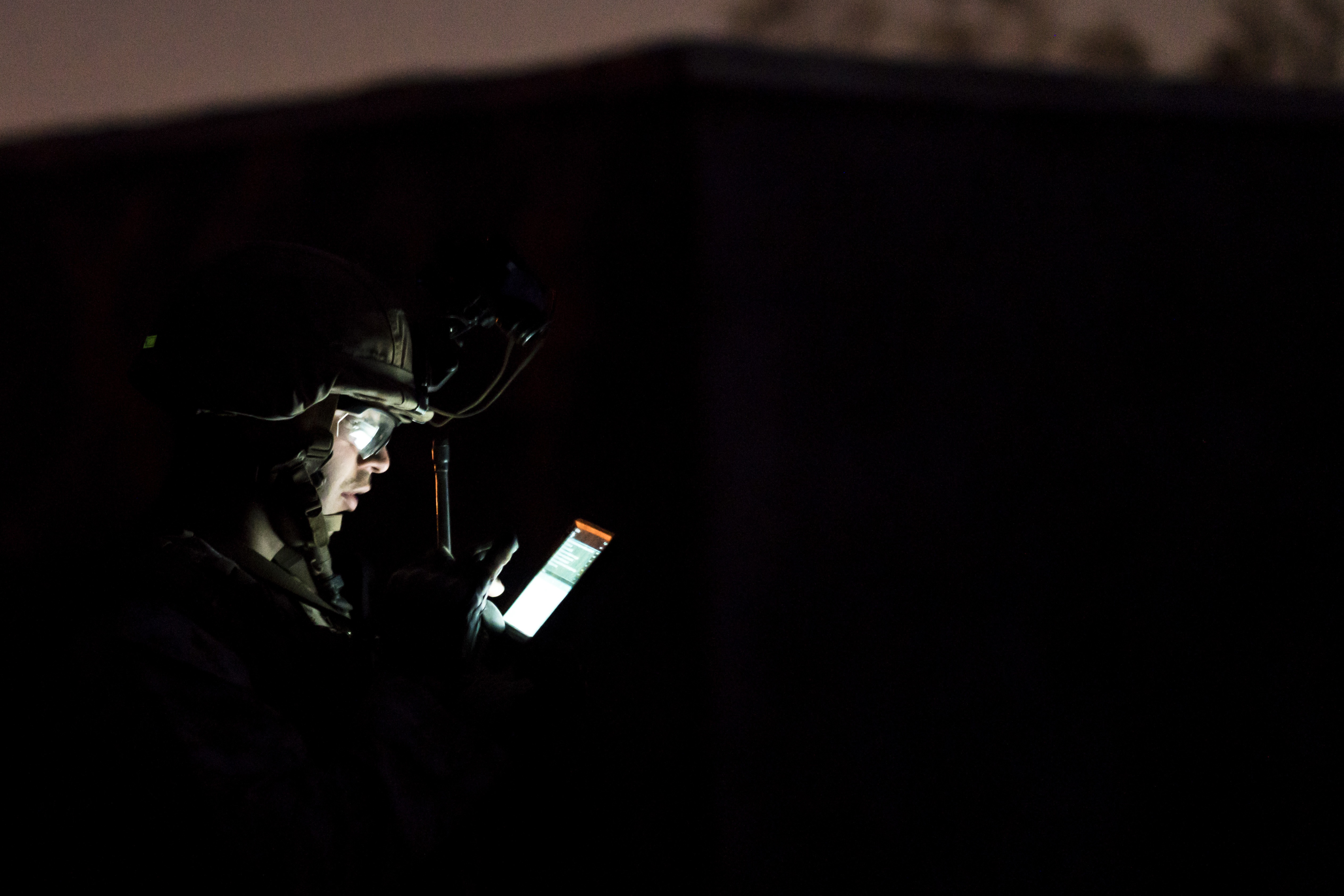 U.S. Marine uses tablet during simulated raid at night HD Wallpaper