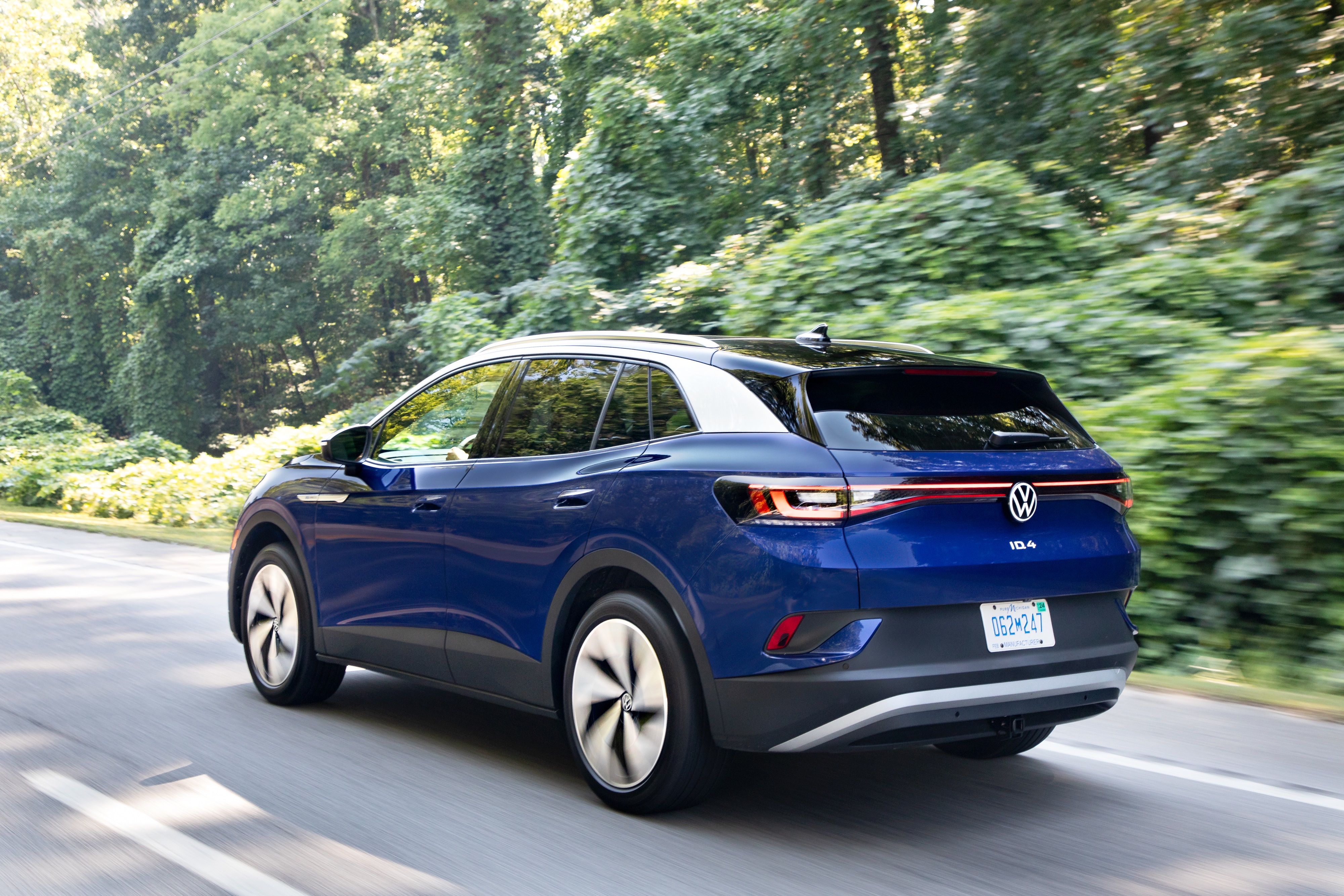 Blue Volkswagen ID.4 AWD Pro S driving on a road HD Wallpaper