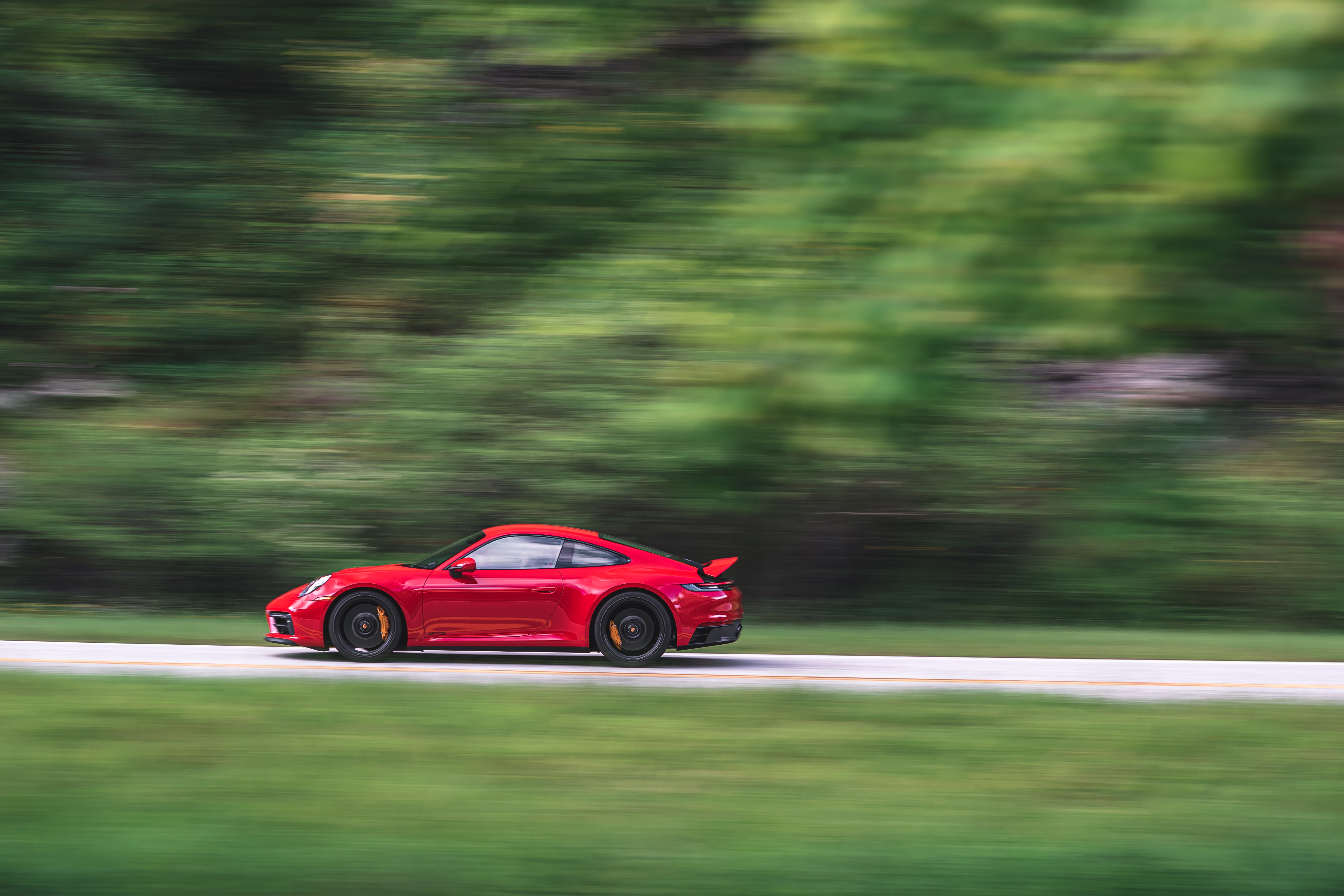Red Porsche 911 Carrera GTS 4K driving on road HD Wallpaper