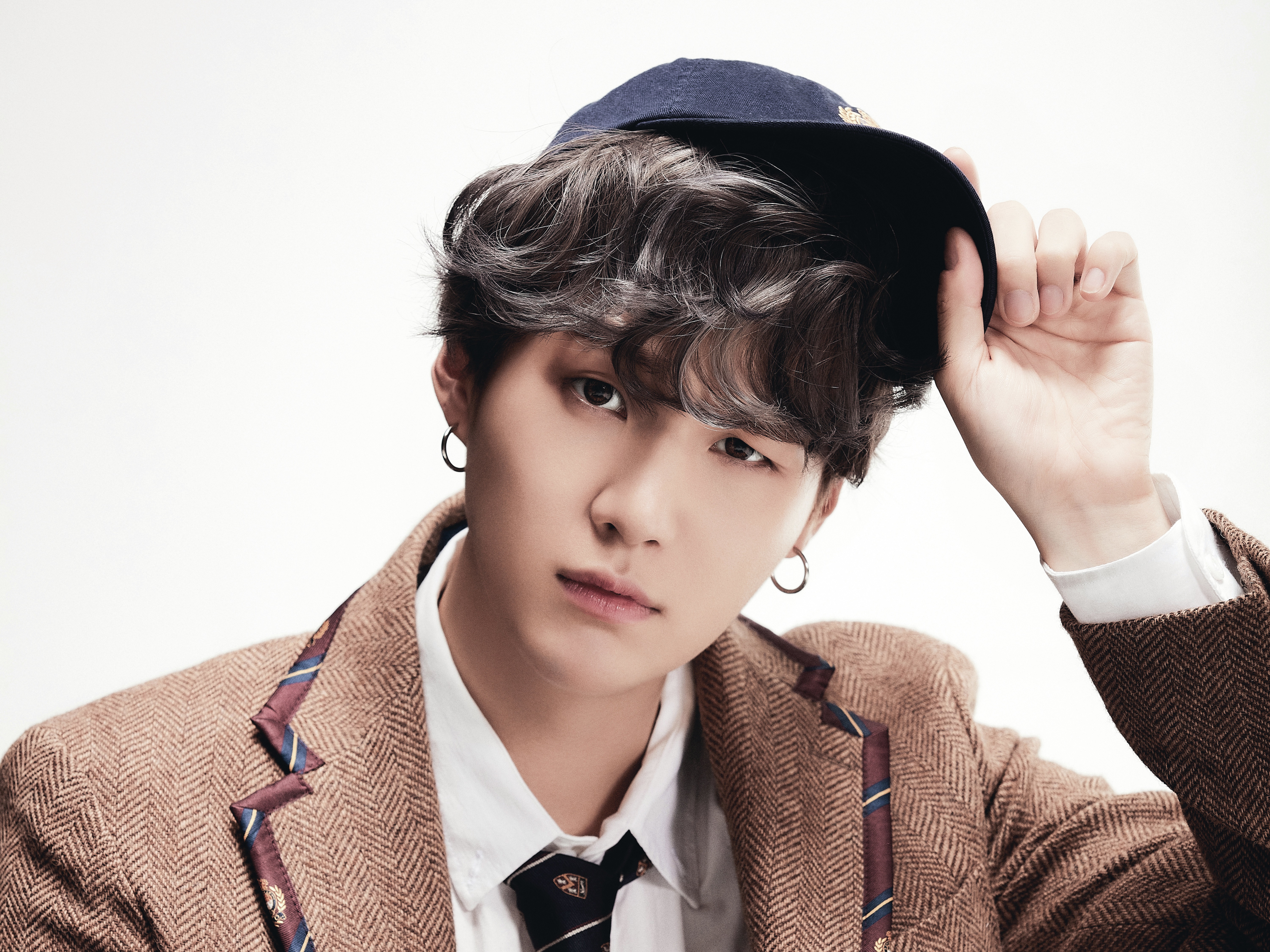 Suga from BTS wearing a brown jacket and blue cap HD Wallpaper