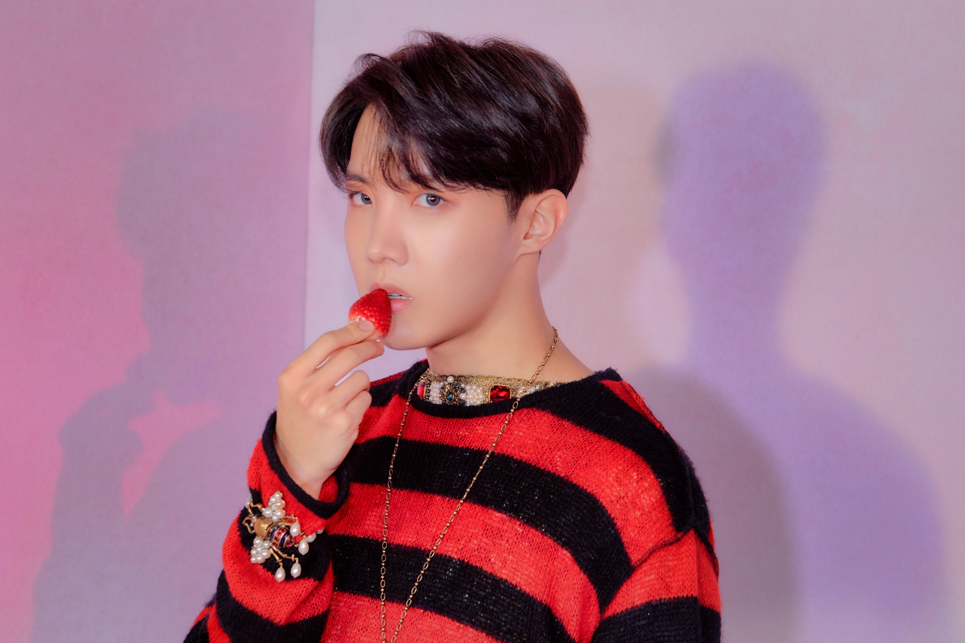 J-Hope from BTS eating a strawberry HD Wallpaper