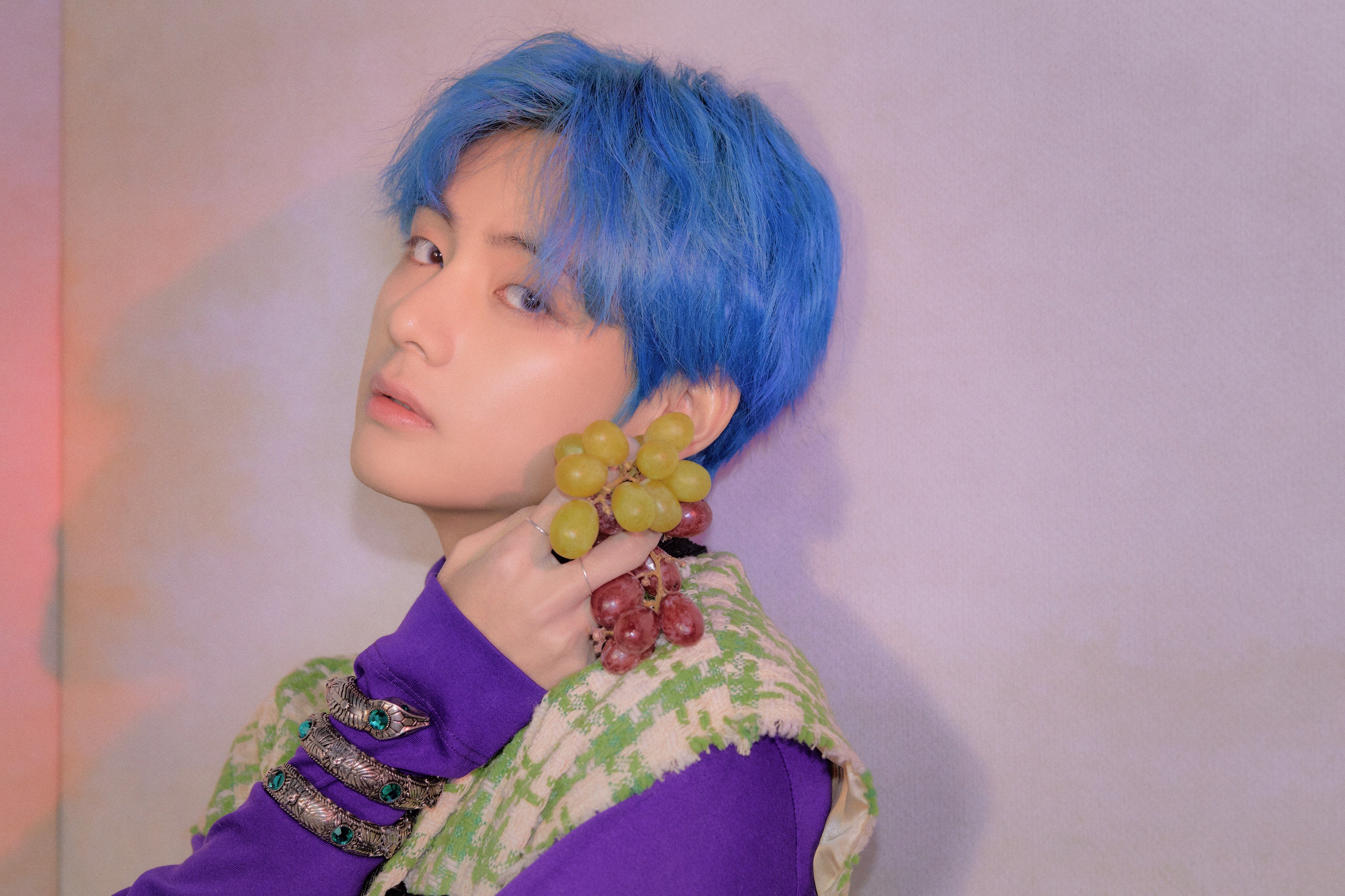 V from BTS with blue hair holding grapes HD Wallpaper