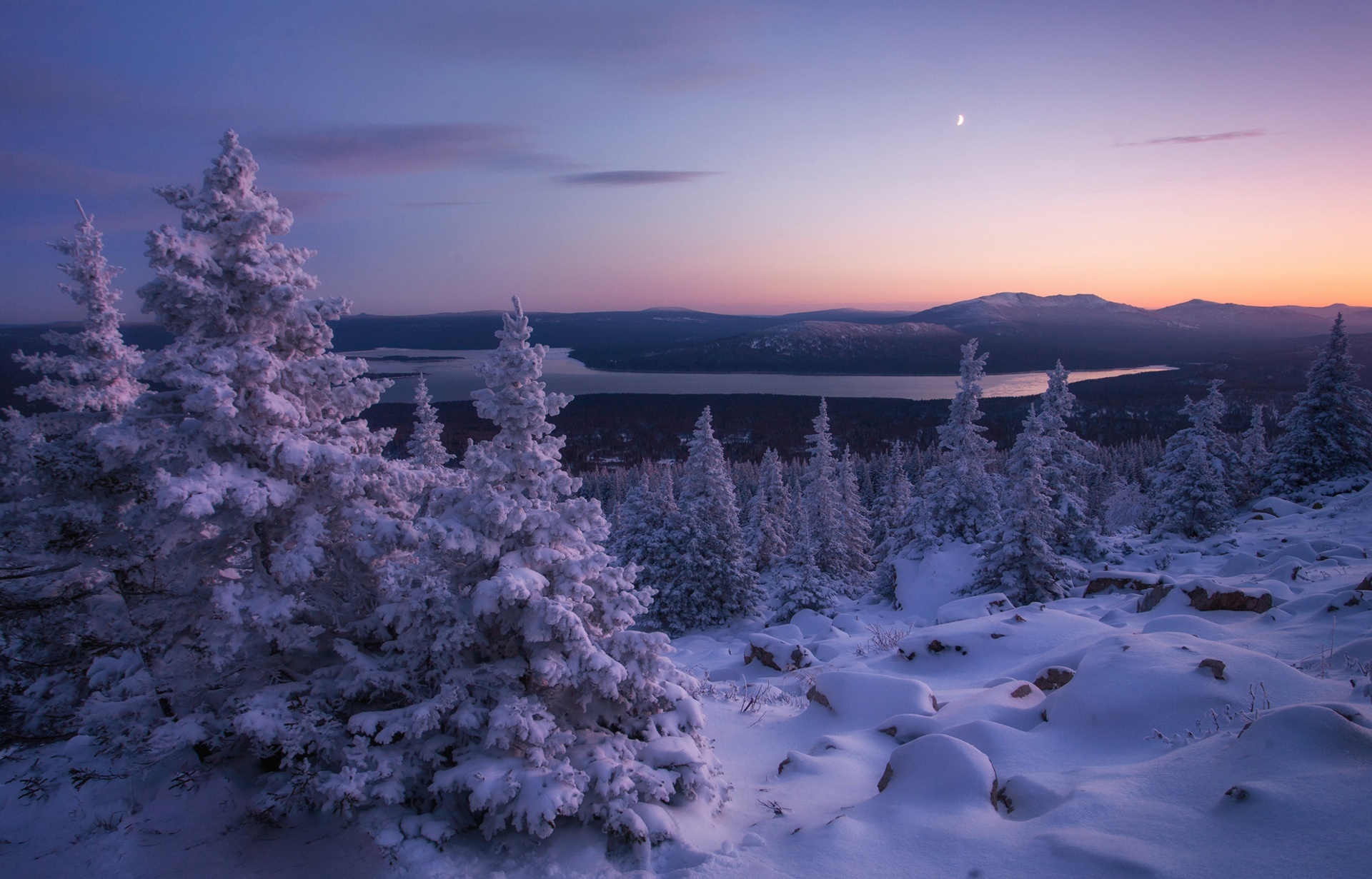 Winter landscape with snow-covered trees and a lake at sunset HD Wallpaper