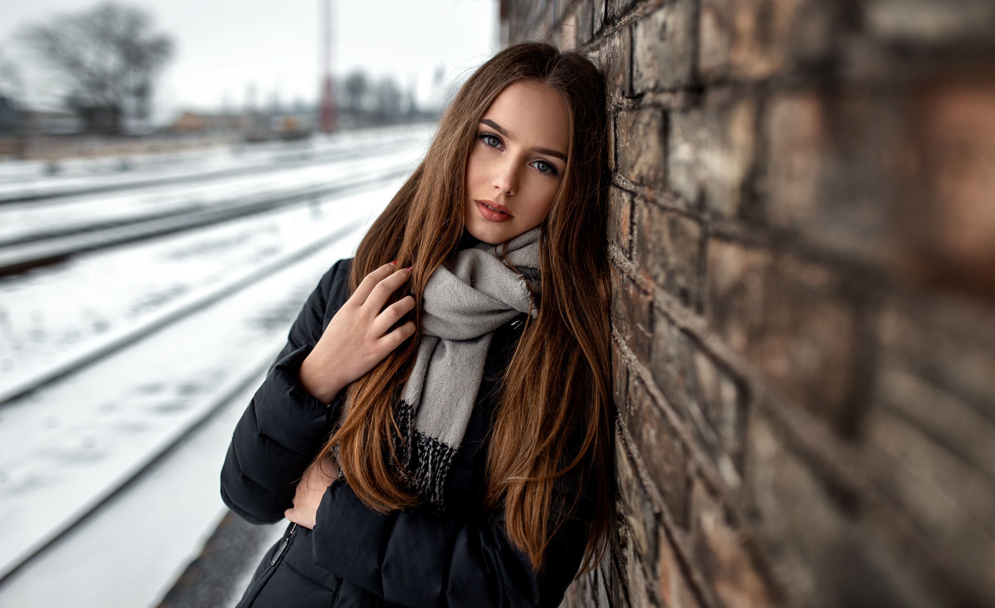 Woman in Scarf by Brick Wall and Train Tracks HD Wallpaper