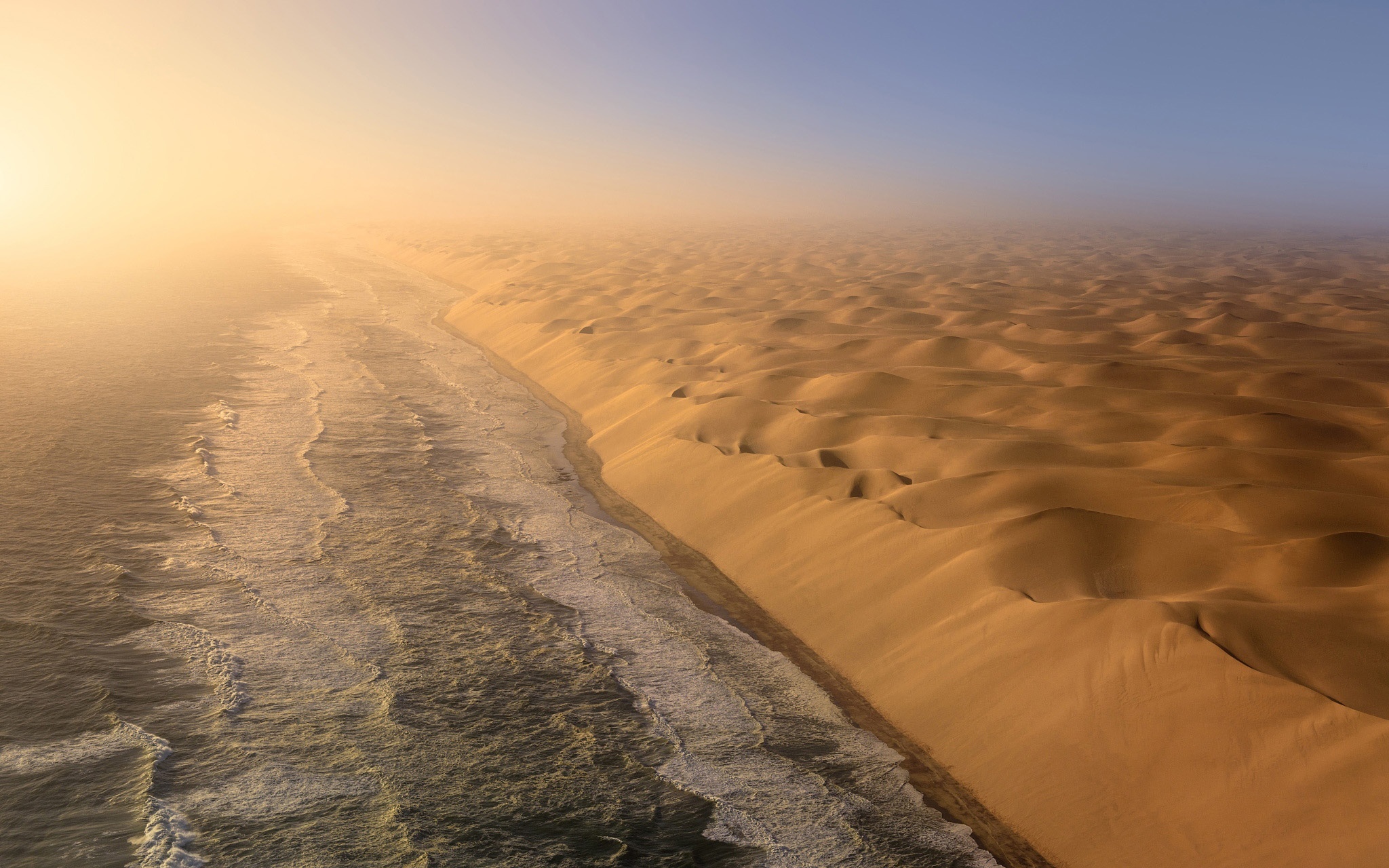 Namib Desert coastline at sunrise with fog HD Wallpaper