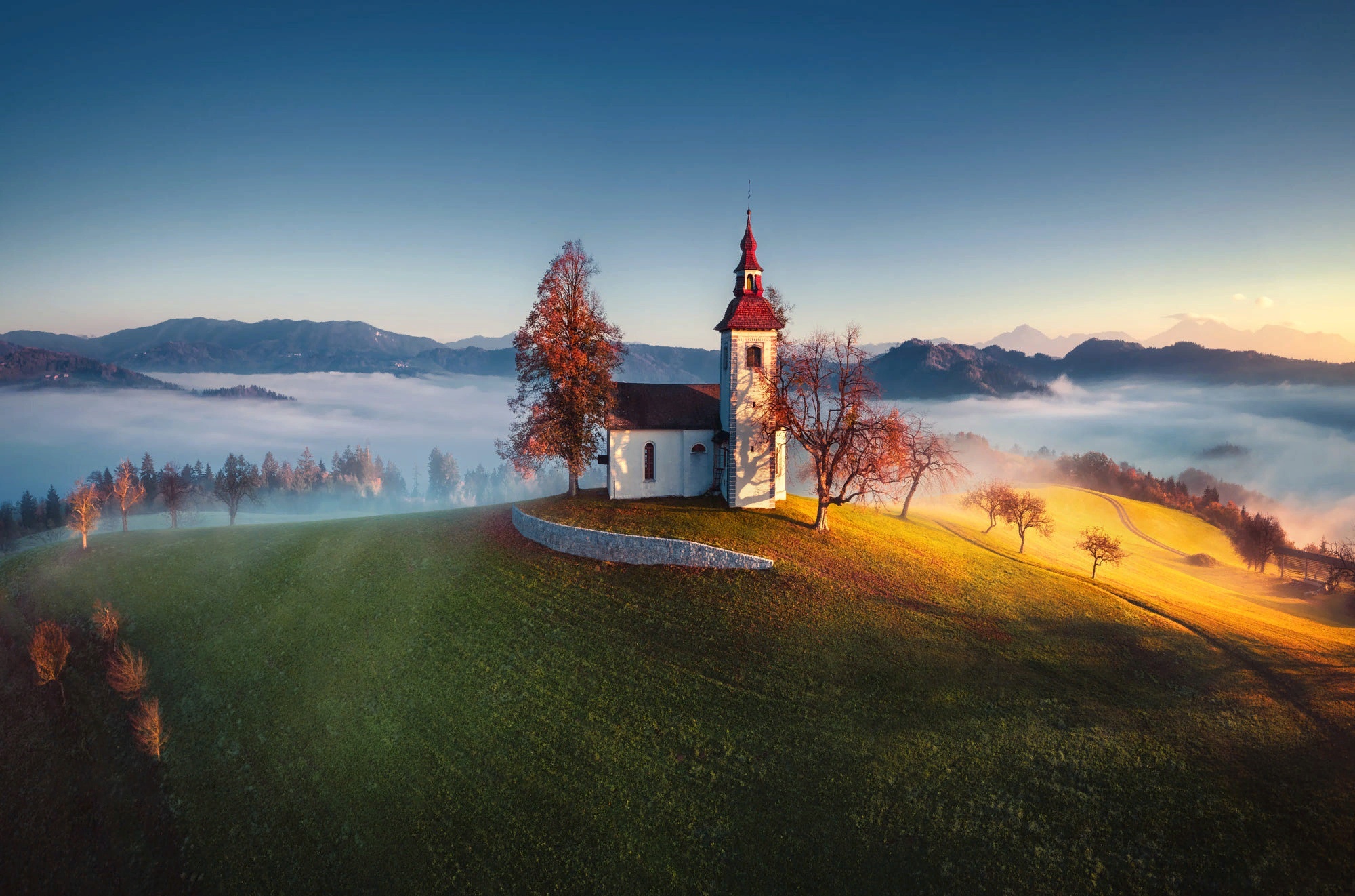Church on a hill in Slovenia with fog HD Wallpaper