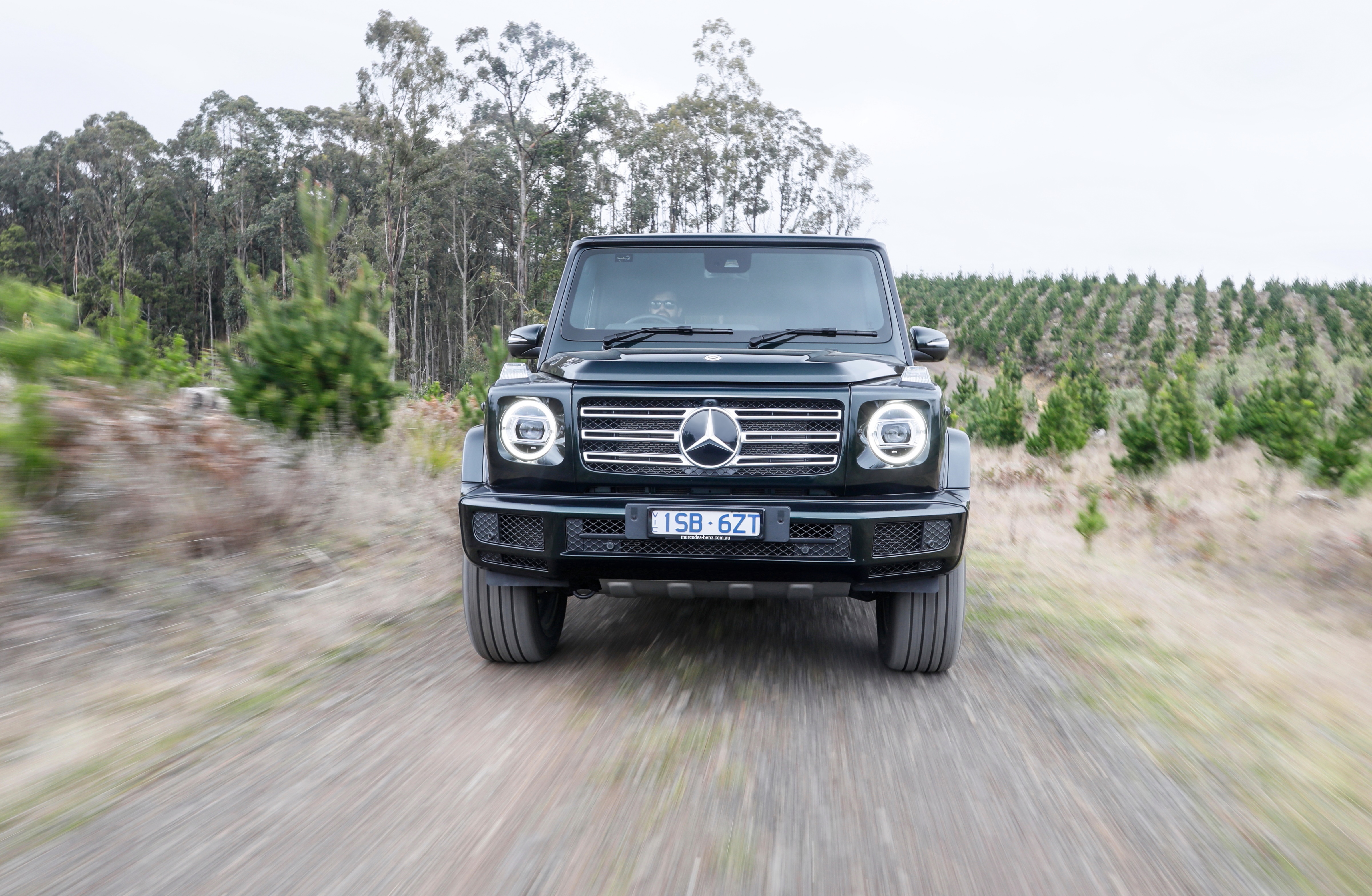 Mercedes-Benz G-Class 400 driving on a dirt road HD Wallpaper
