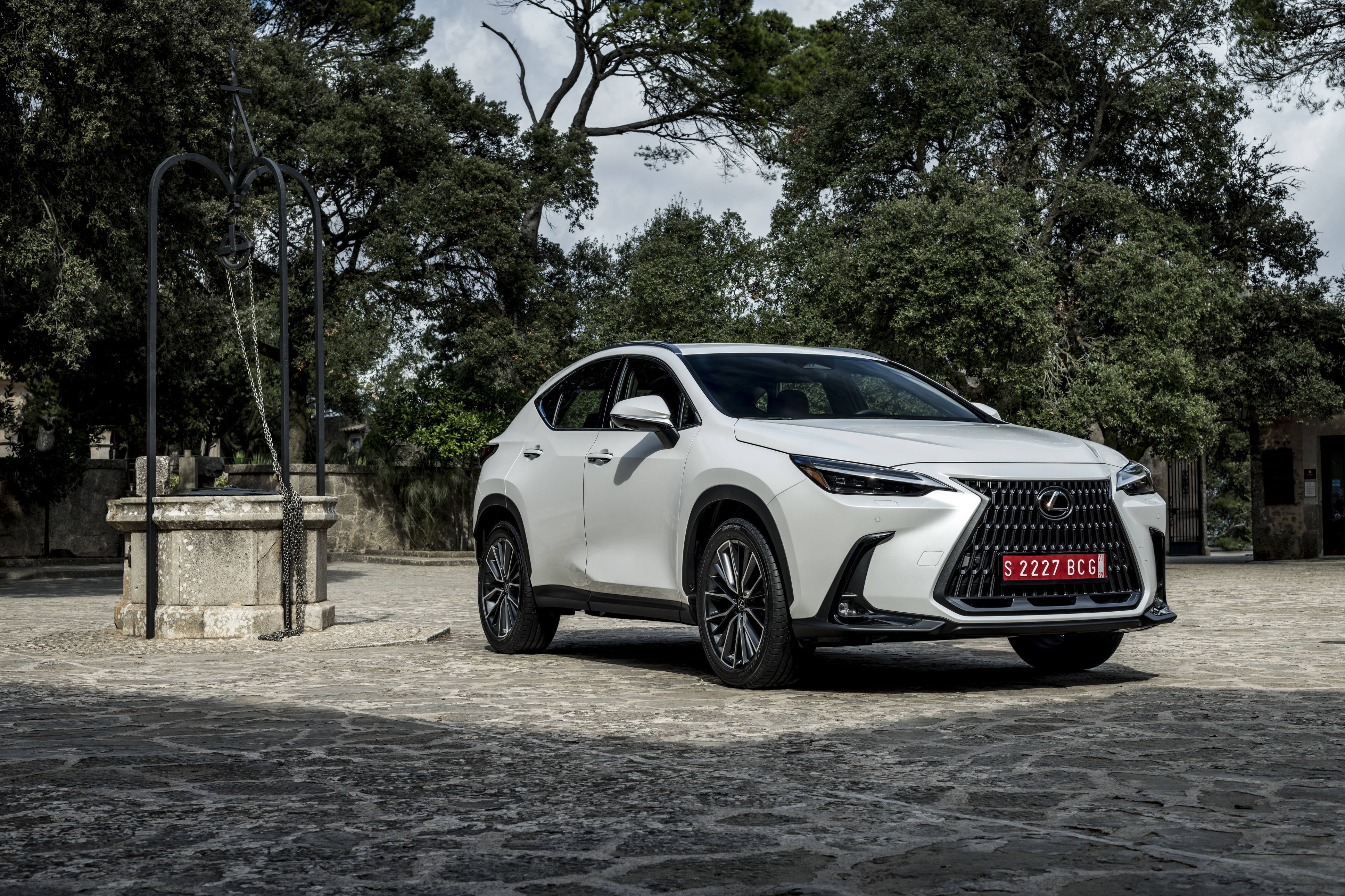 White Lexus NX 250 4K parked near a stone well HD Wallpaper
