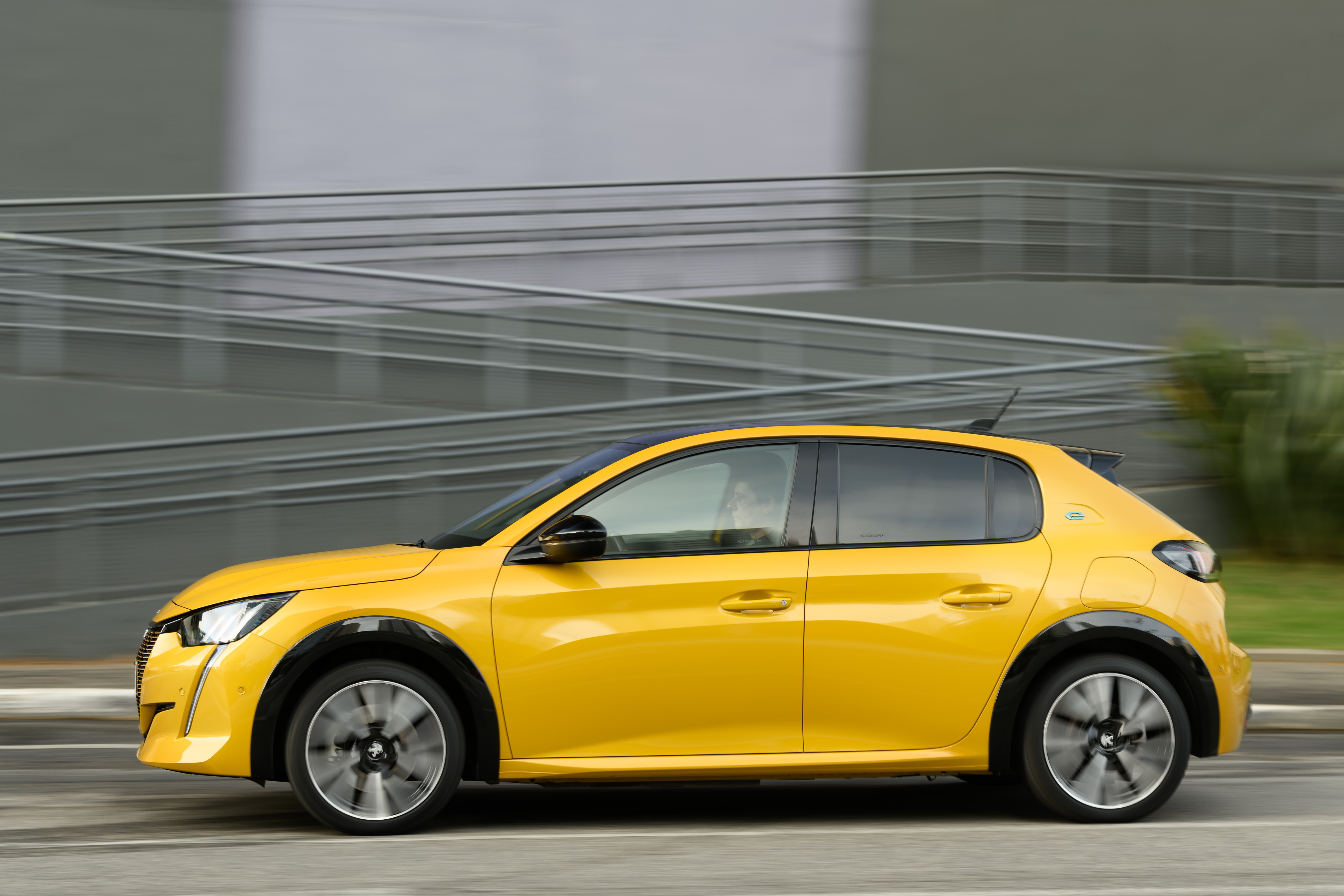 Yellow Peugeot E-208 GT electric car driving HD Wallpaper