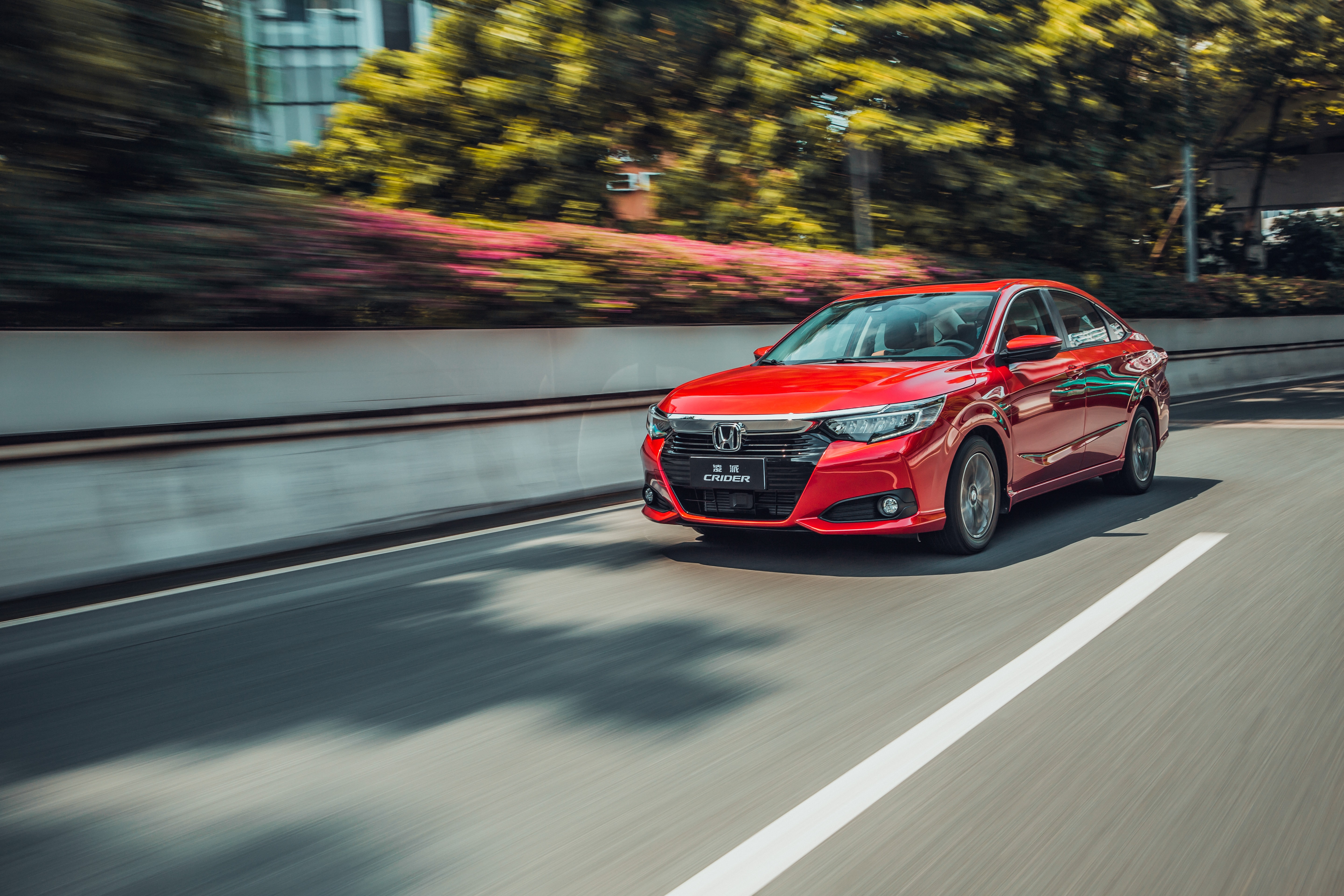 Red Honda Crider Sport Hybrid driving on a road HD Wallpaper
