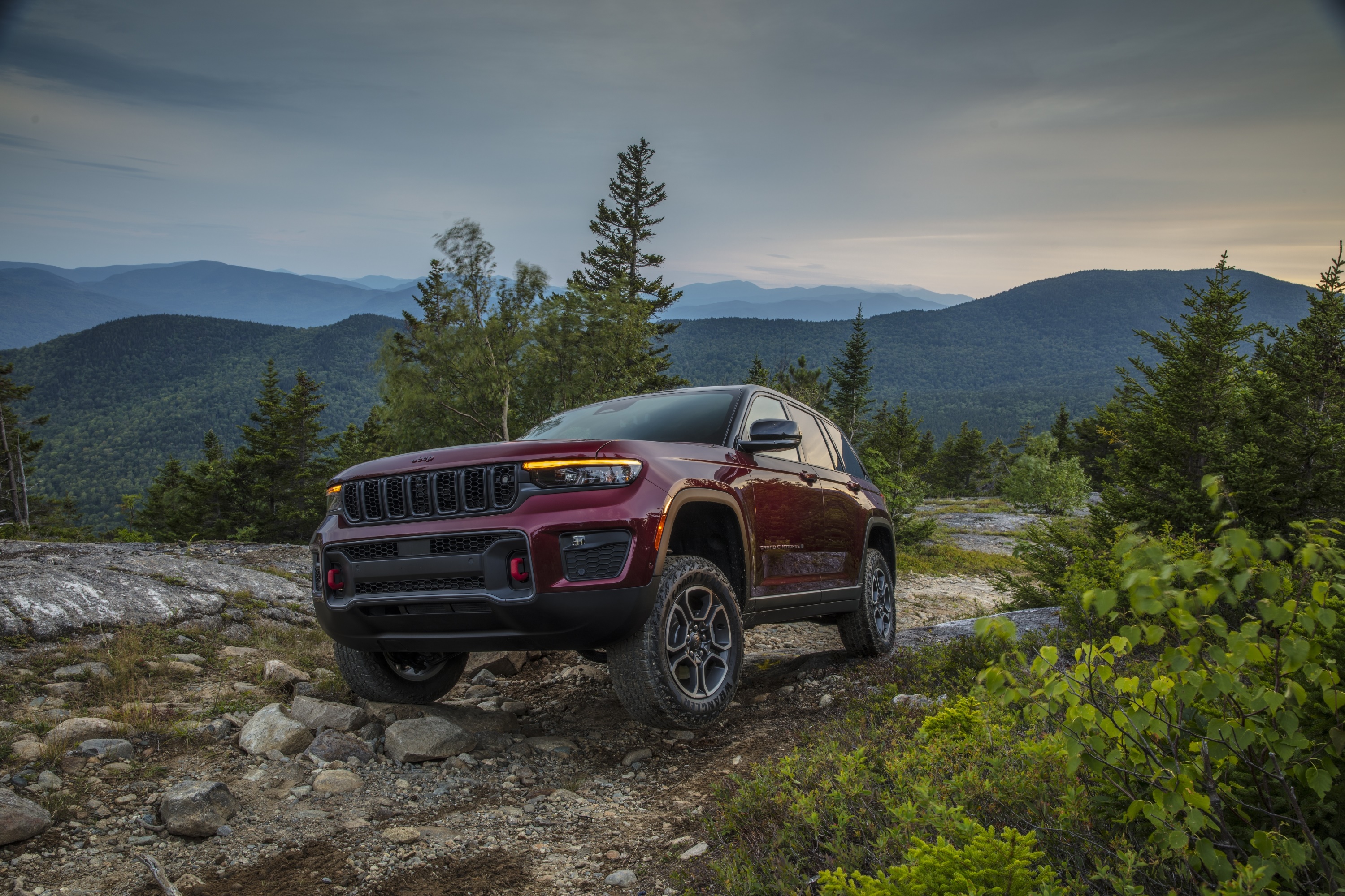 2022 Jeep Grand Cherokee Trailhawk on a mountain road HD Wallpaper