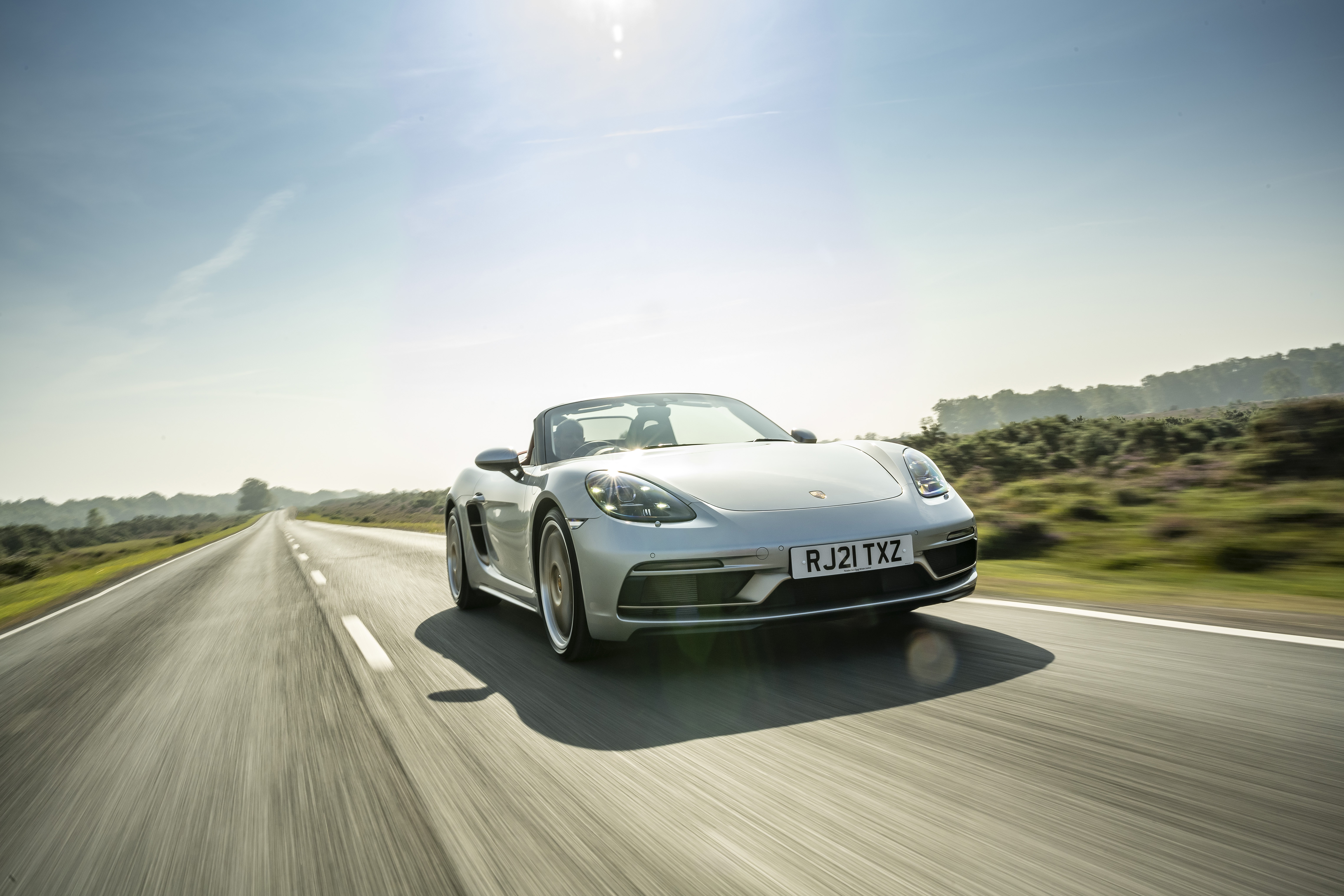 Silver Porsche Boxster Cabriolet on a road HD Wallpaper