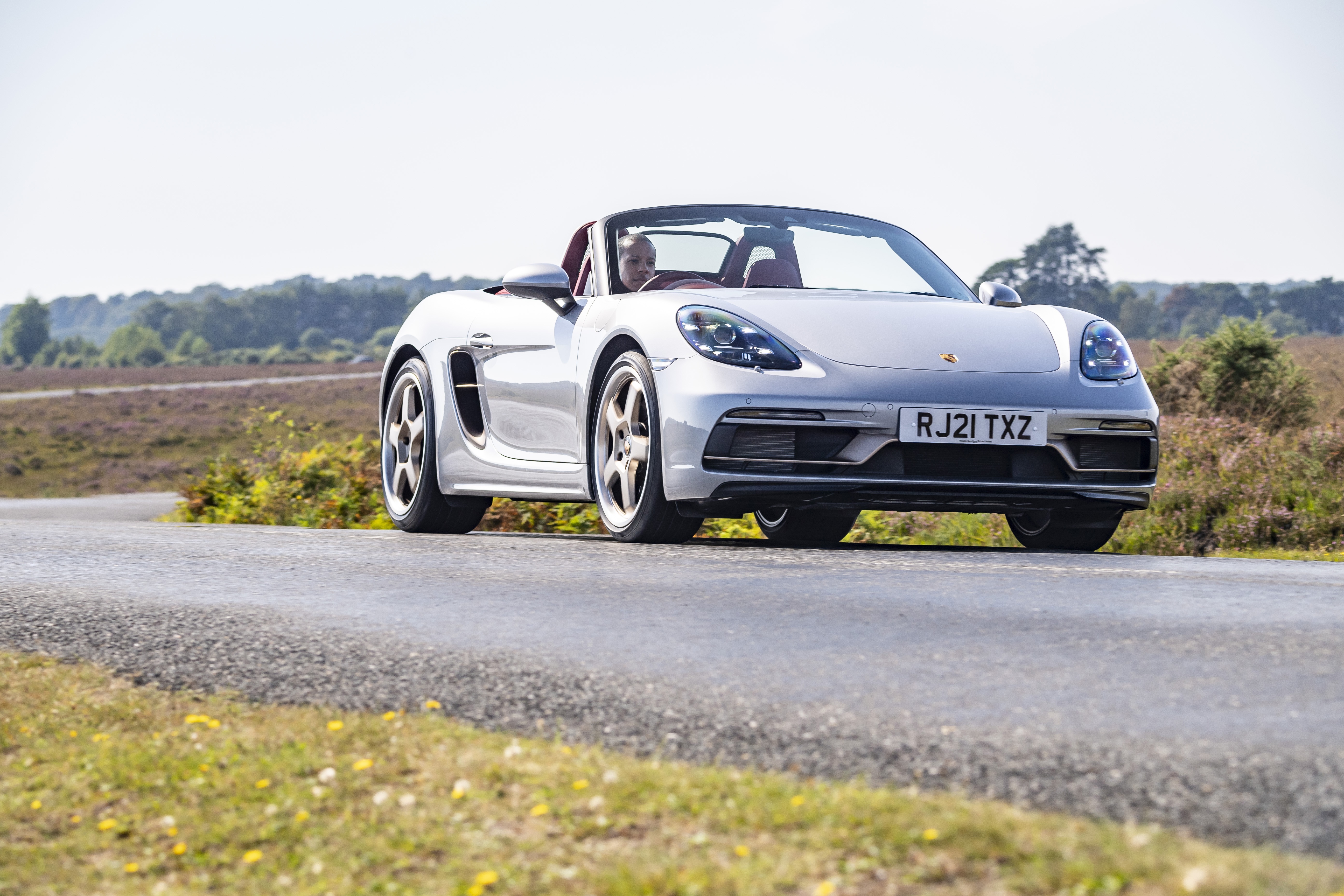 Silver Porsche Boxster Cabriolet on a road HD Wallpaper
