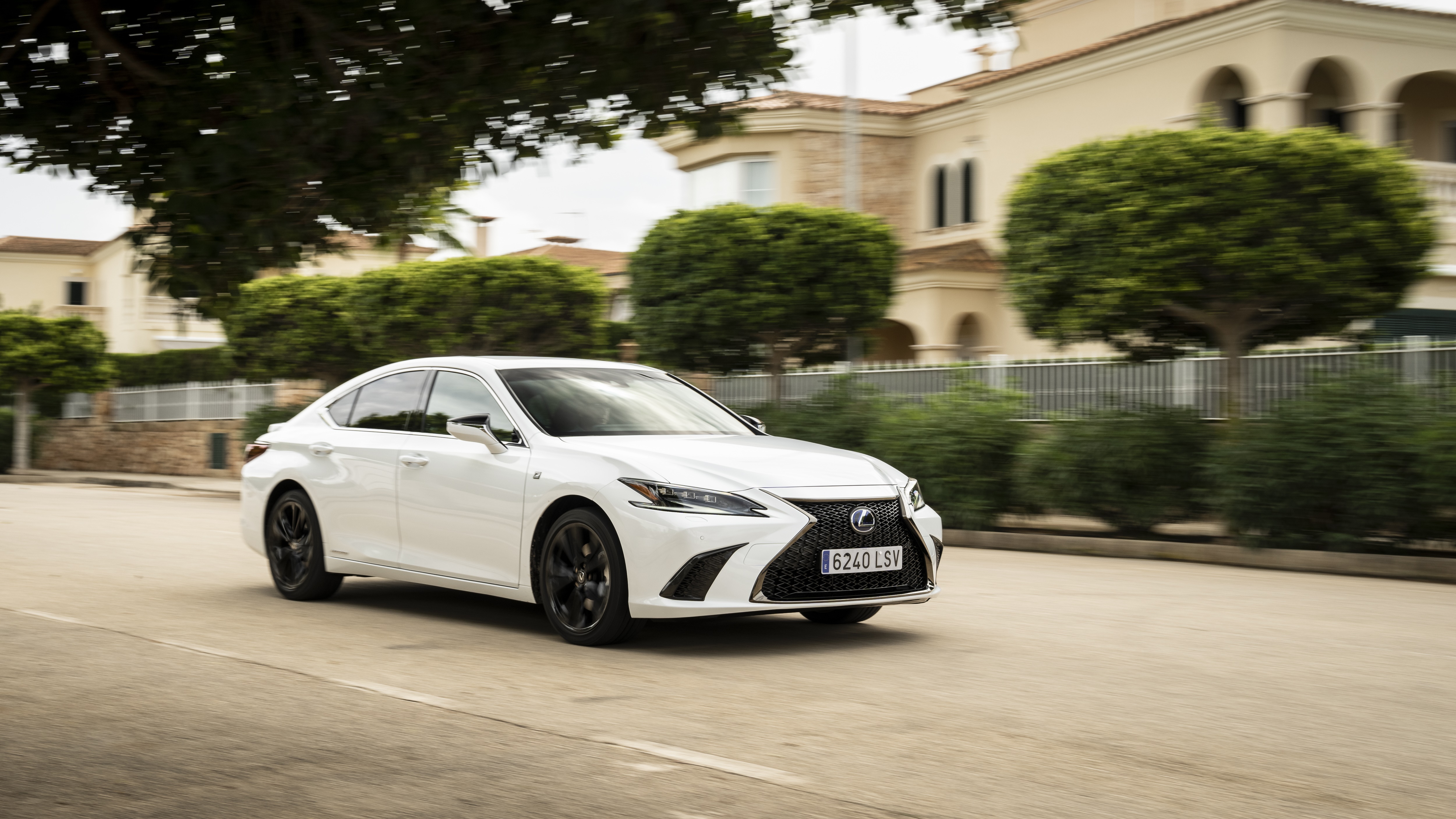 White Lexus ES 300h F SPORT driving on a street HD Wallpaper