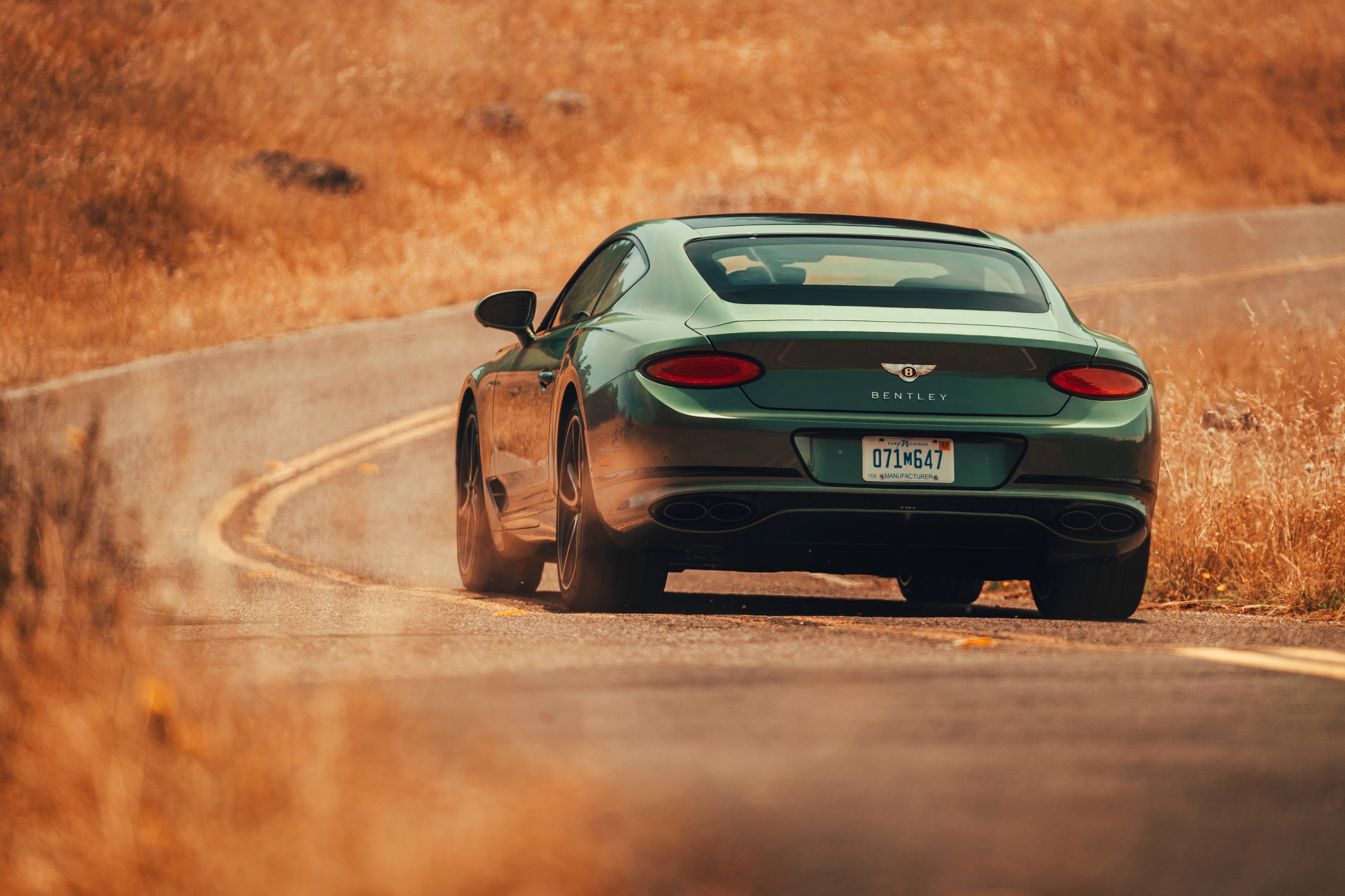 Green Bentley Continental GT V8 on a winding road HD Wallpaper