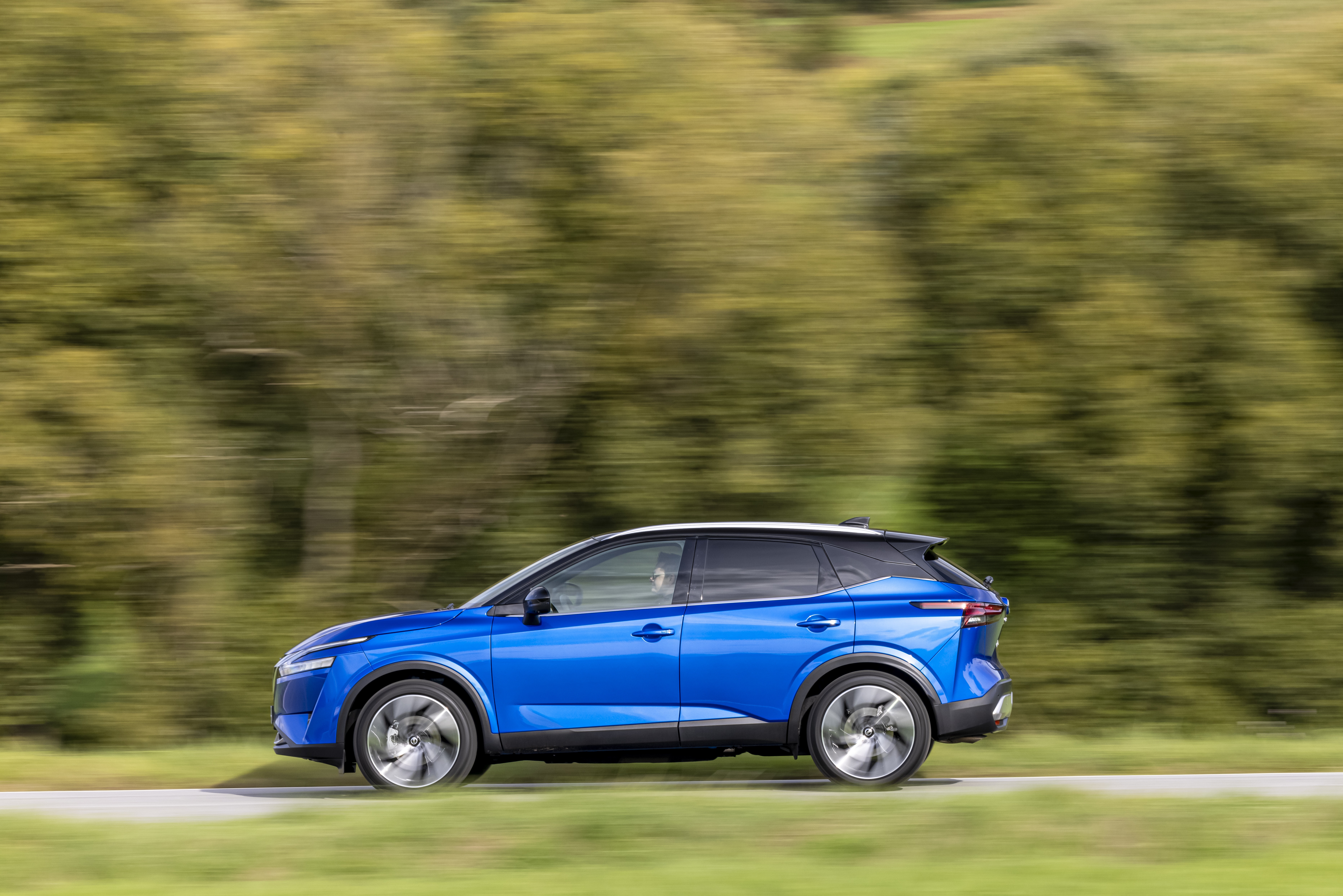 Blue Nissan Qashqai SUV driving on a road HD Wallpaper