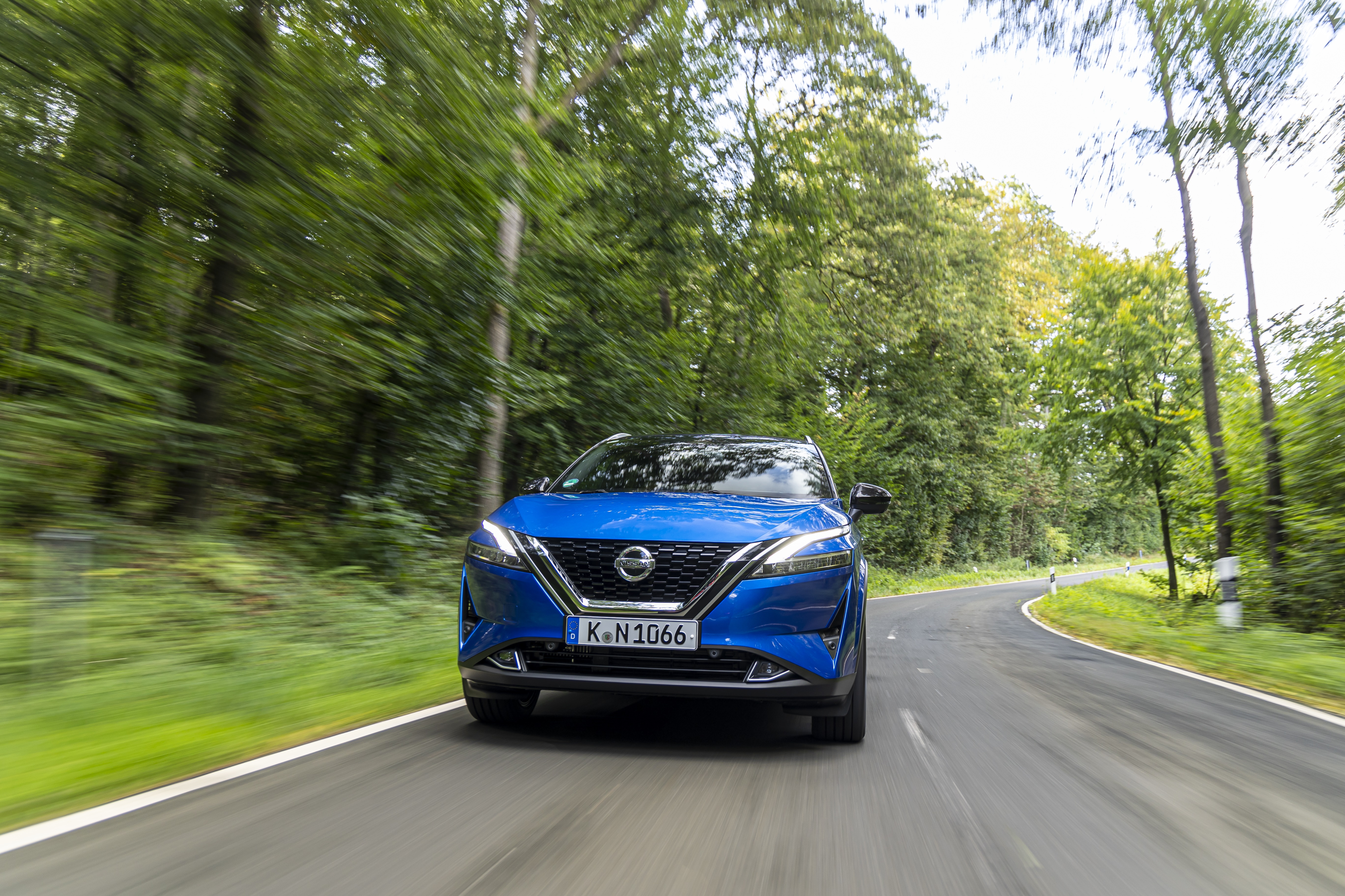 Blue Nissan Qashqai driving on a forest road HD Wallpaper