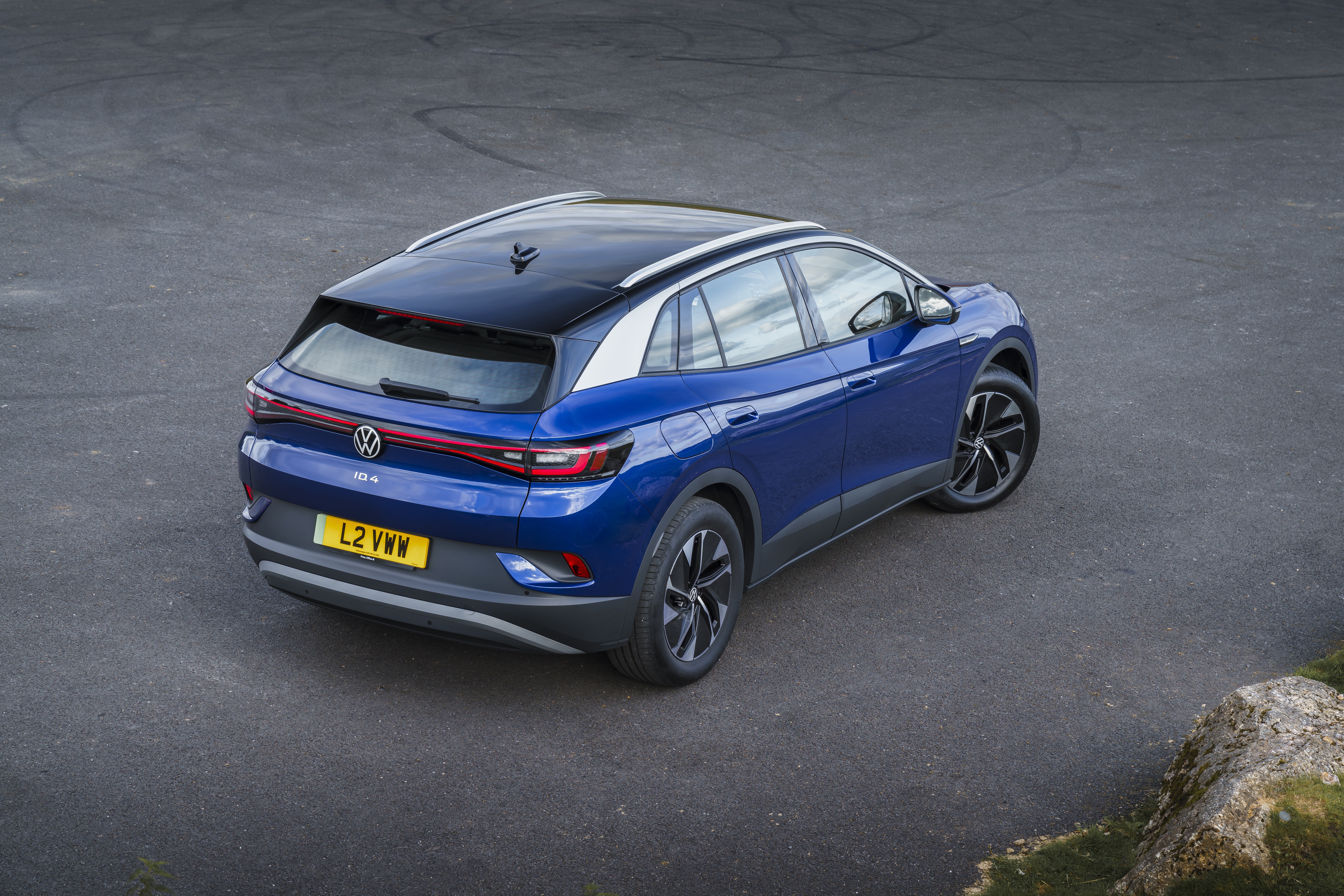 Blue Volkswagen ID.4 electric car on asphalt HD Wallpaper