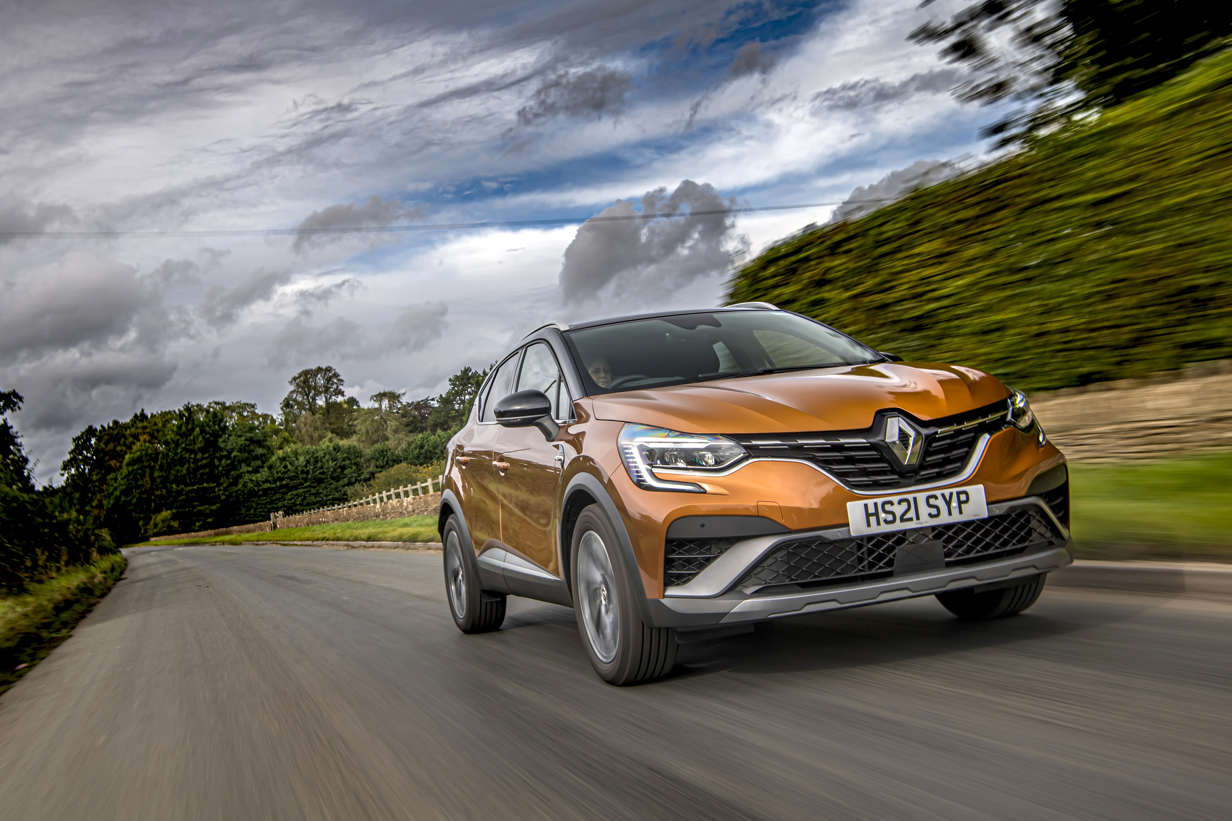 Renault Captur E-TECH Hybrid R.S. Line driving on road HD Wallpaper