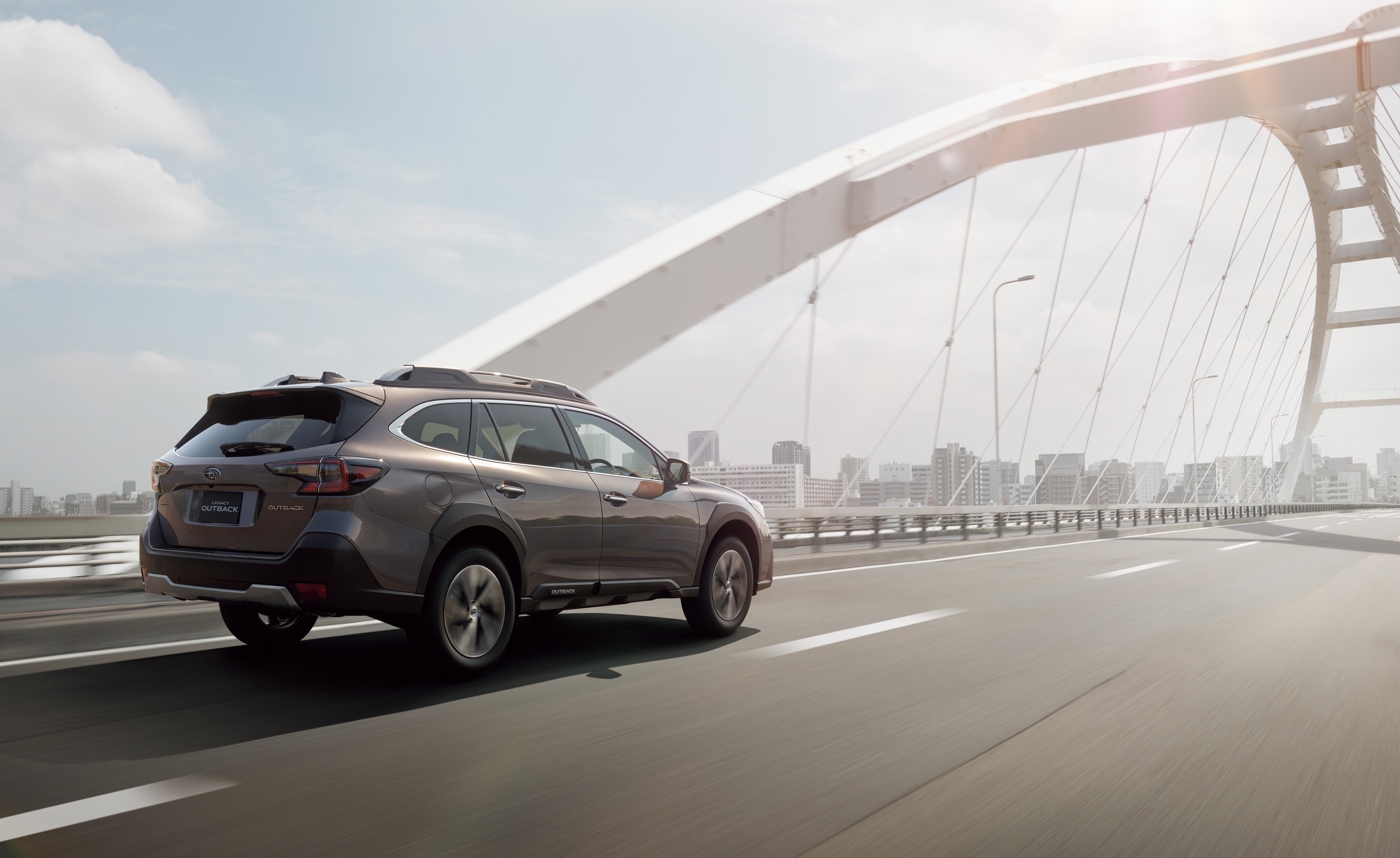 Subaru Outback driving on a bridge HD Wallpaper