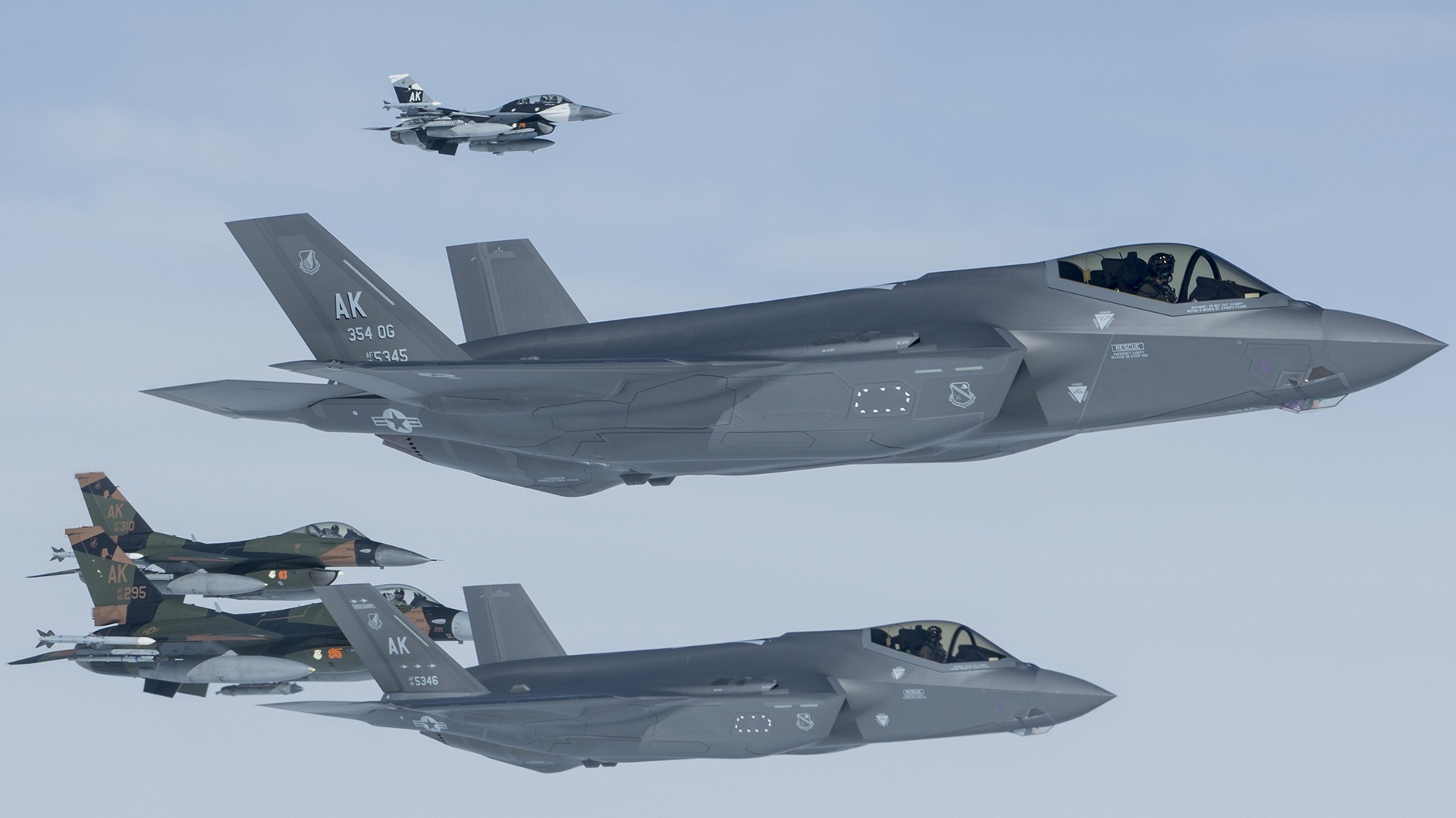 F-35 Lightning II and F-16 Fighting Falcon jets in formation HD Wallpaper