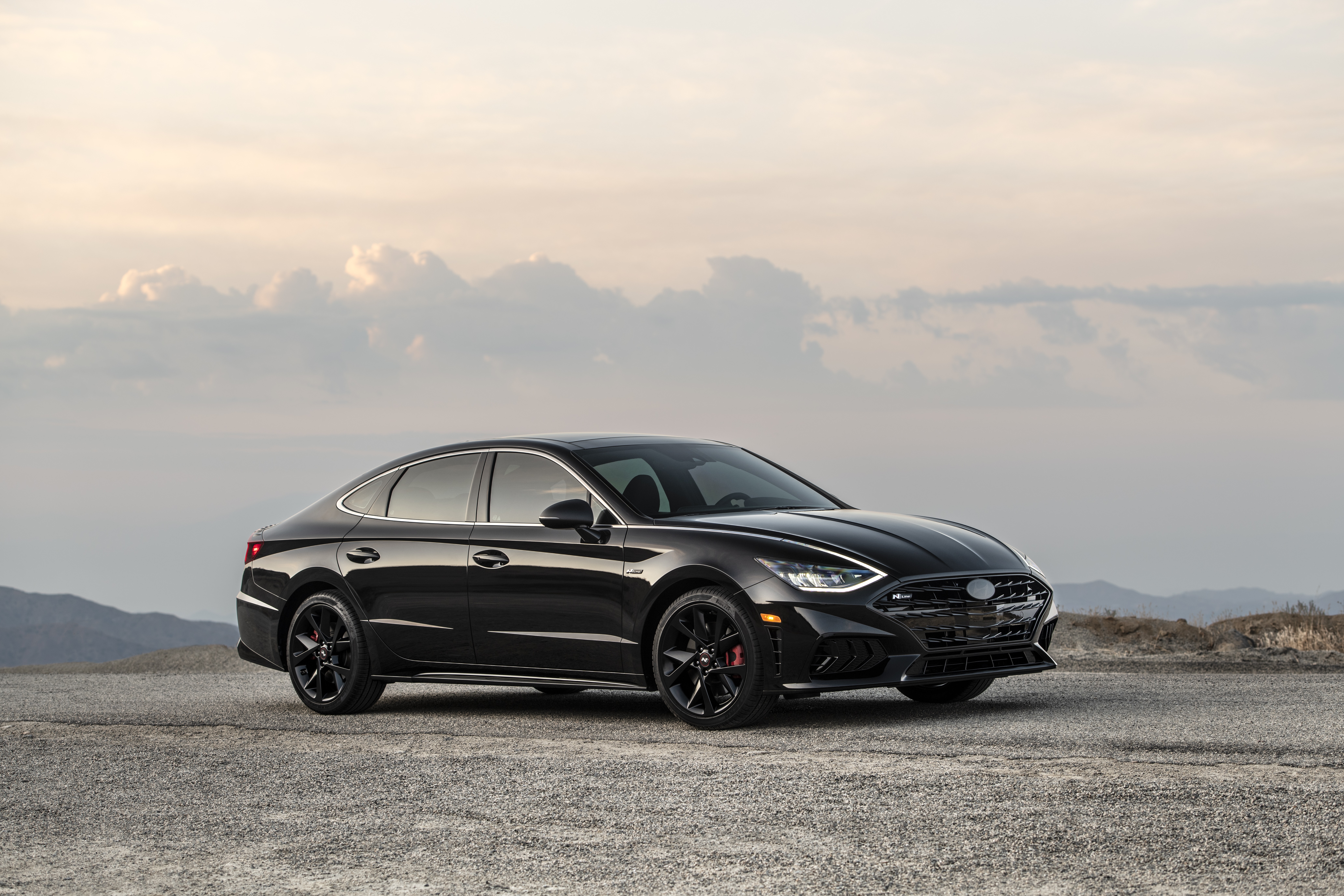 Black Hyundai Sonata N Line sedan on gravel road HD Wallpaper