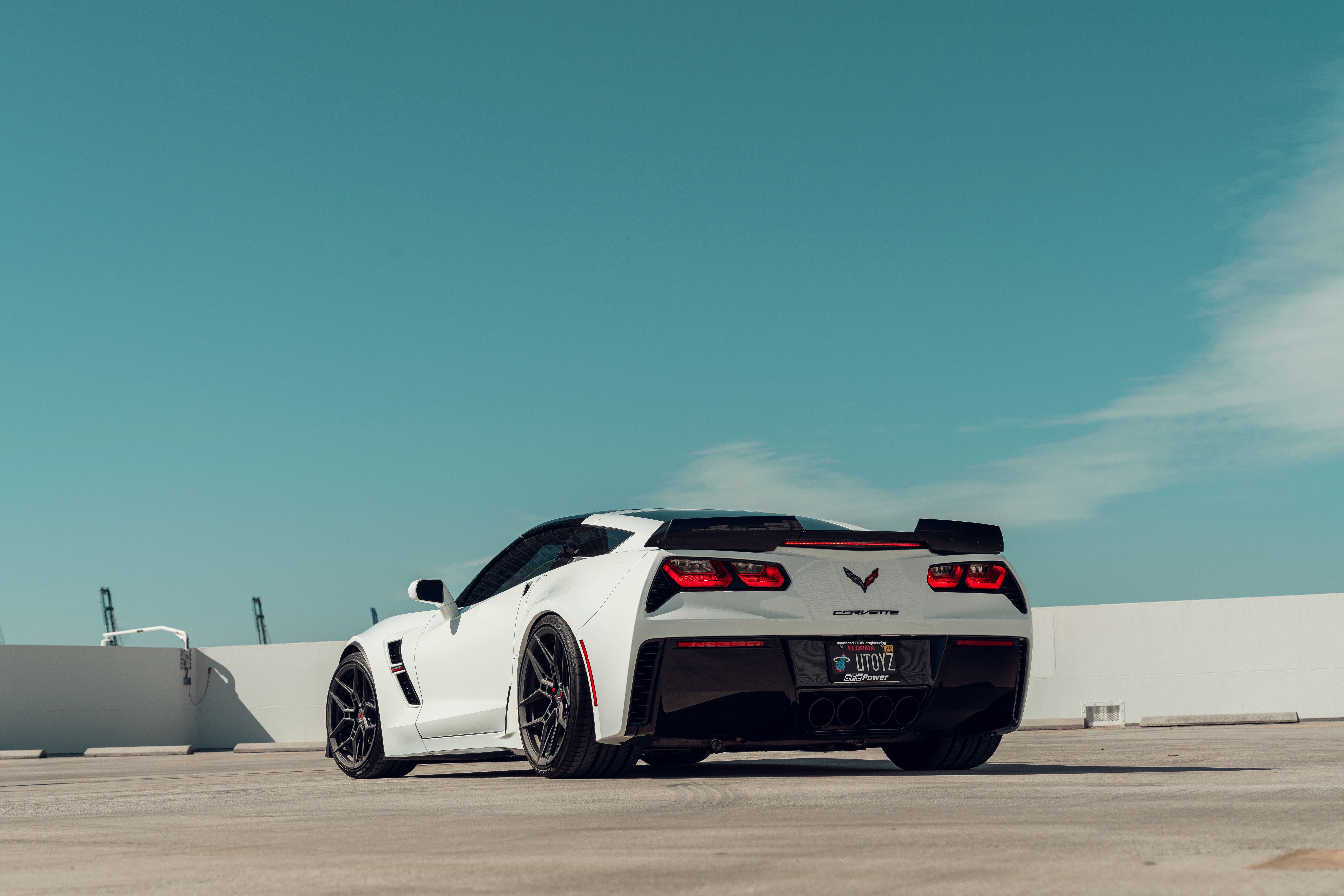 White Chevrolet Corvette C7 on a rooftop HD Wallpaper