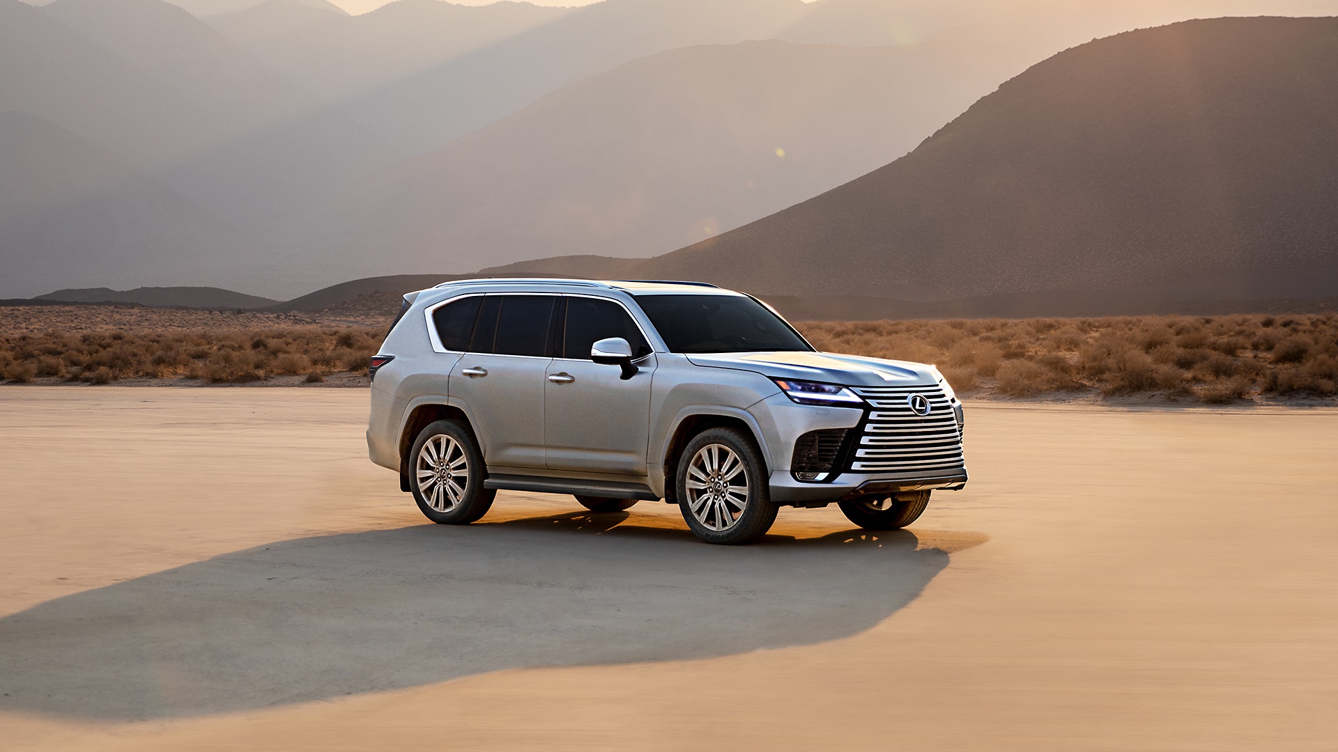 Silver Lexus LX 600 SUV in a desert landscape HD Wallpaper