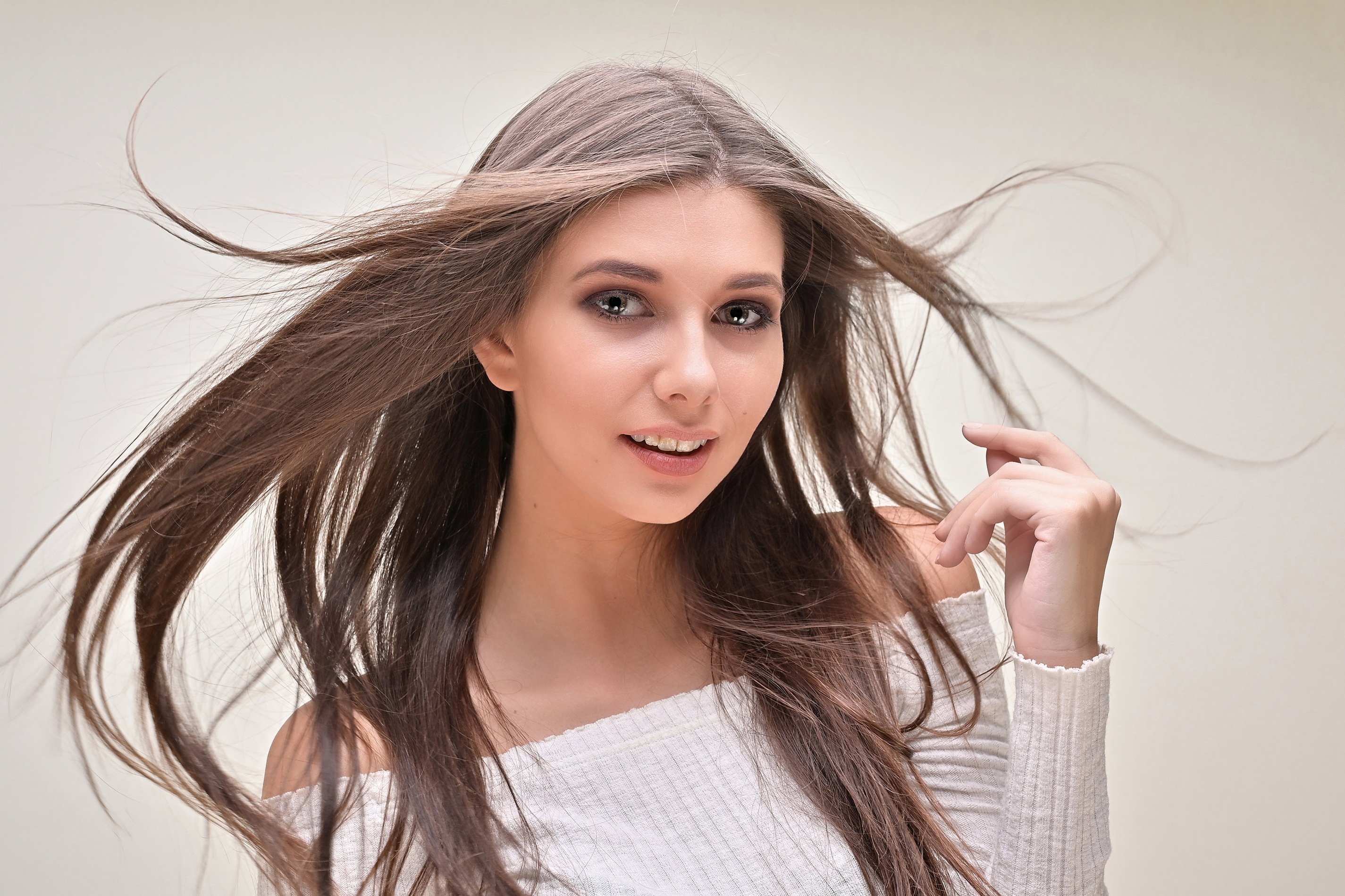 Brunette woman with windblown hair HD Wallpaper
