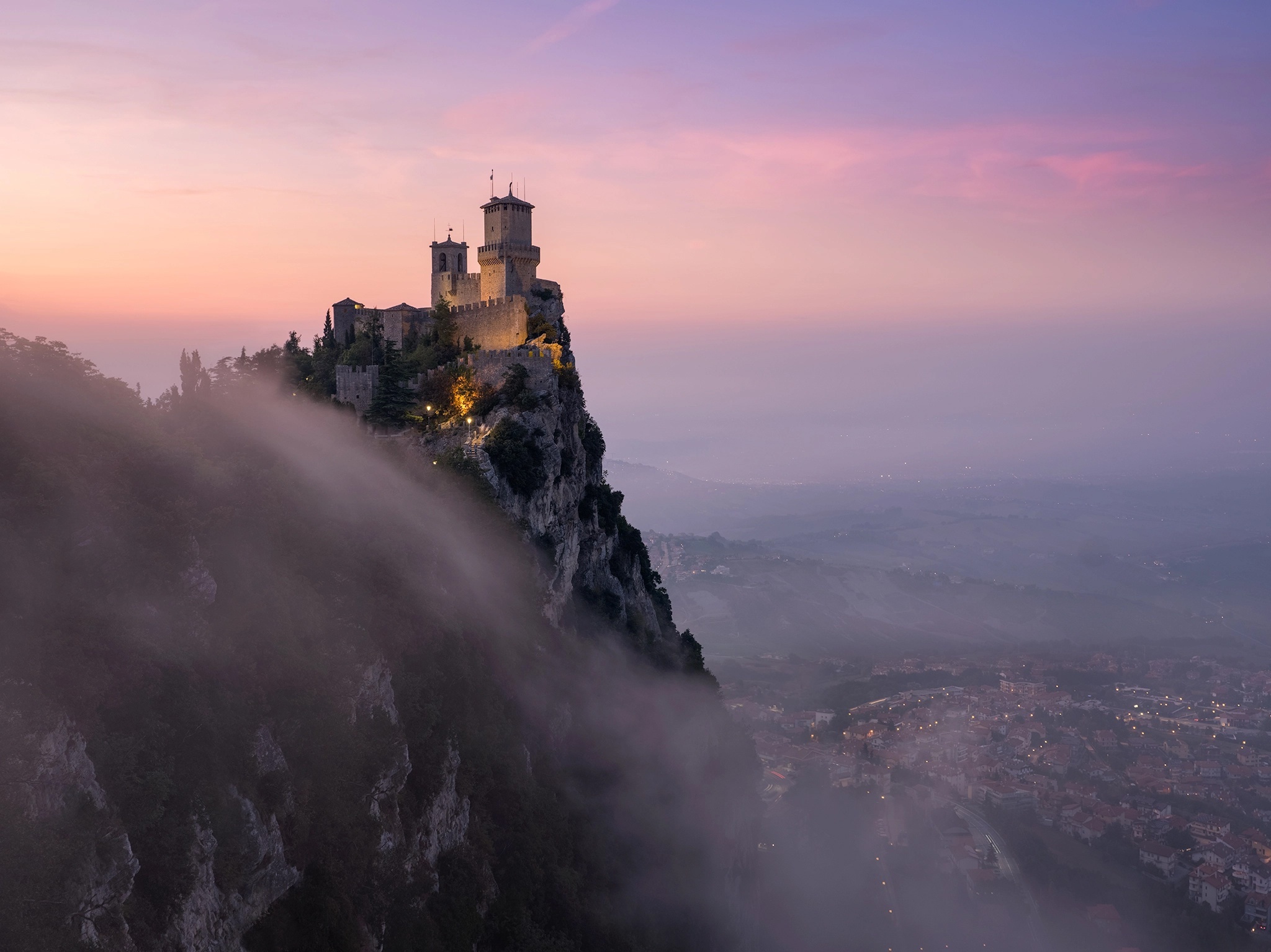 Castle on a cliff at sunrise with fog HD Wallpaper