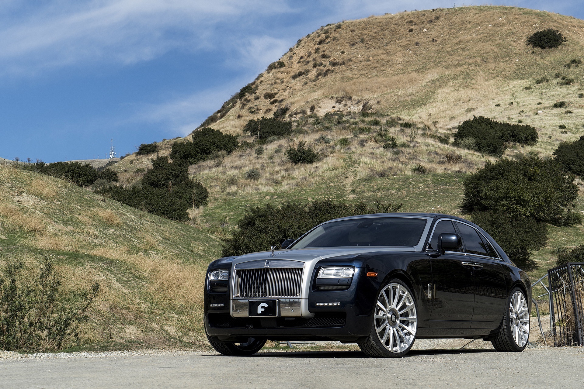 Rolls-Royce Ghost parked on a dirt road with hills HD Wallpaper