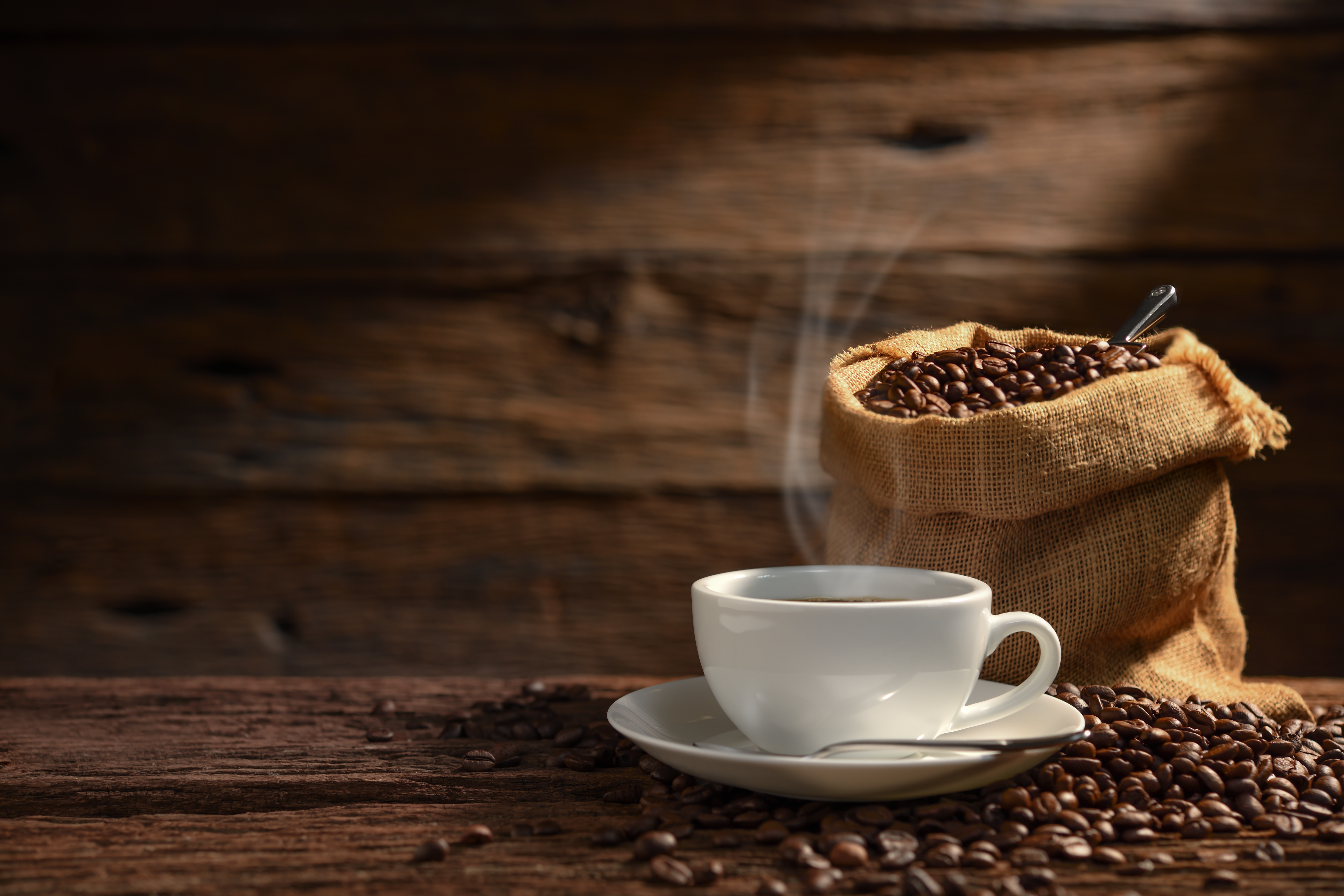 Cup of coffee with coffee beans and burlap sack HD Wallpaper