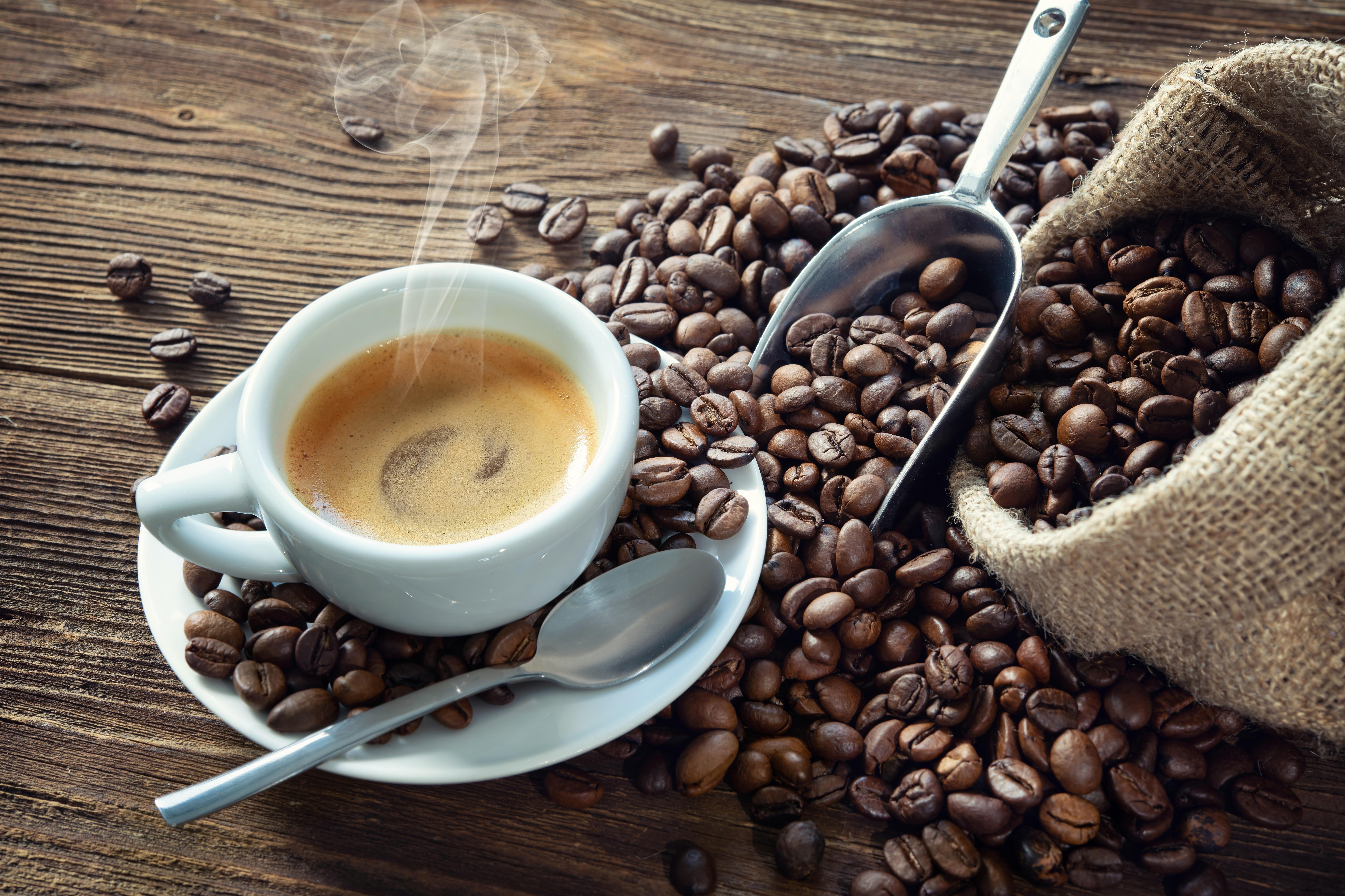 Espresso cup with coffee beans and burlap sack HD Wallpaper