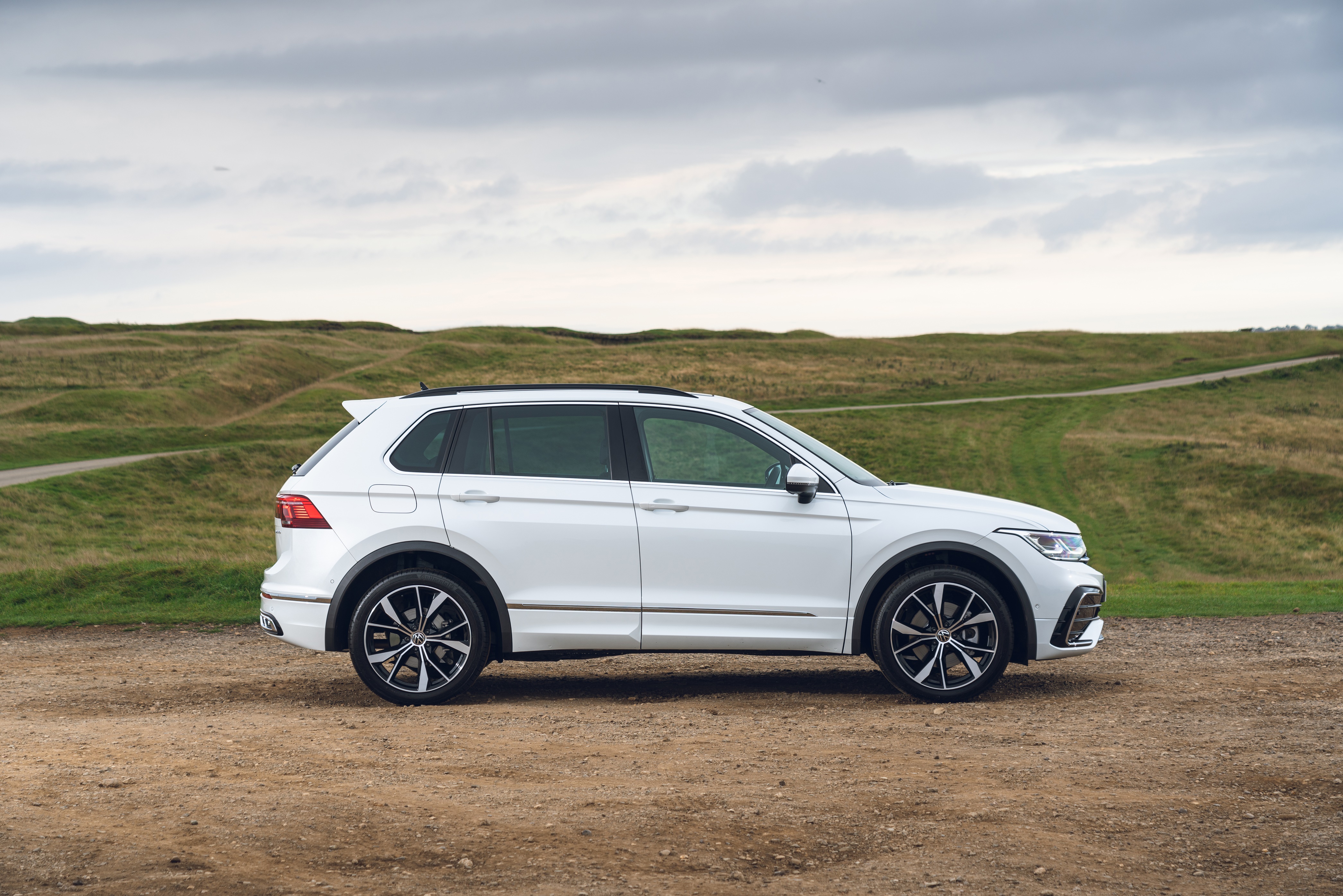 White Volkswagen Tiguan R-Line SUV parked on dirt road HD Wallpaper