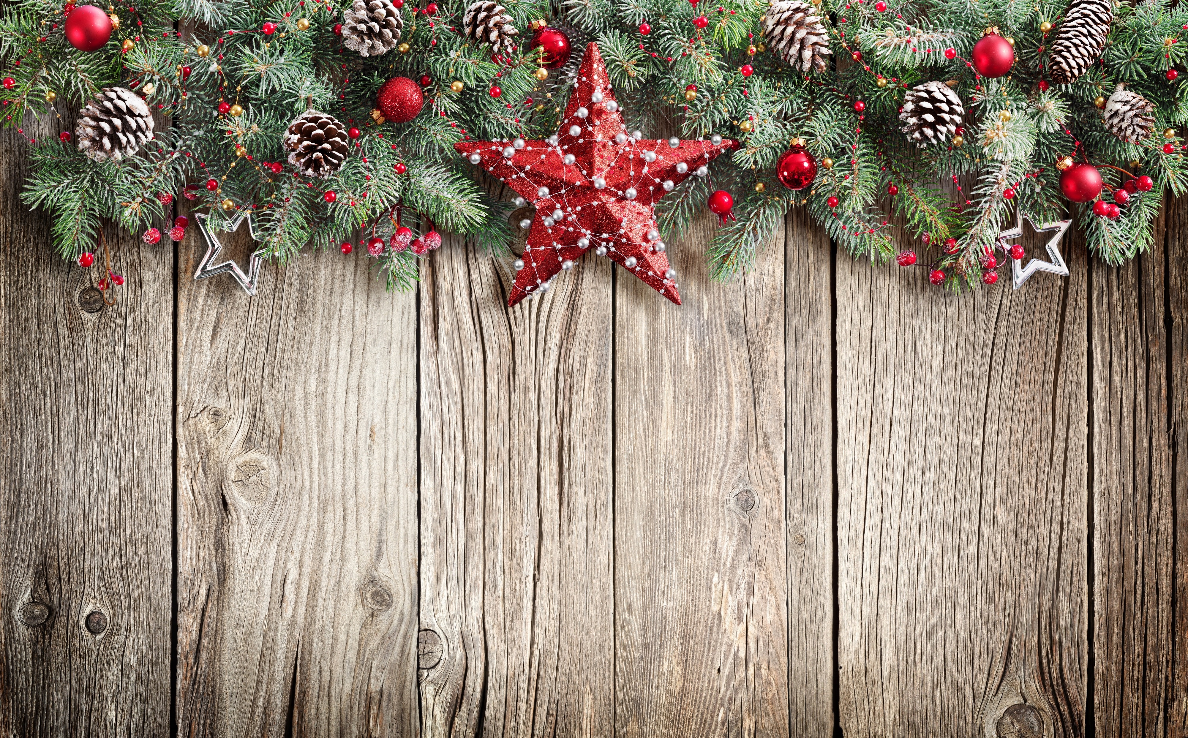 Christmas garland with ornaments and pine cones on wood HD Wallpaper