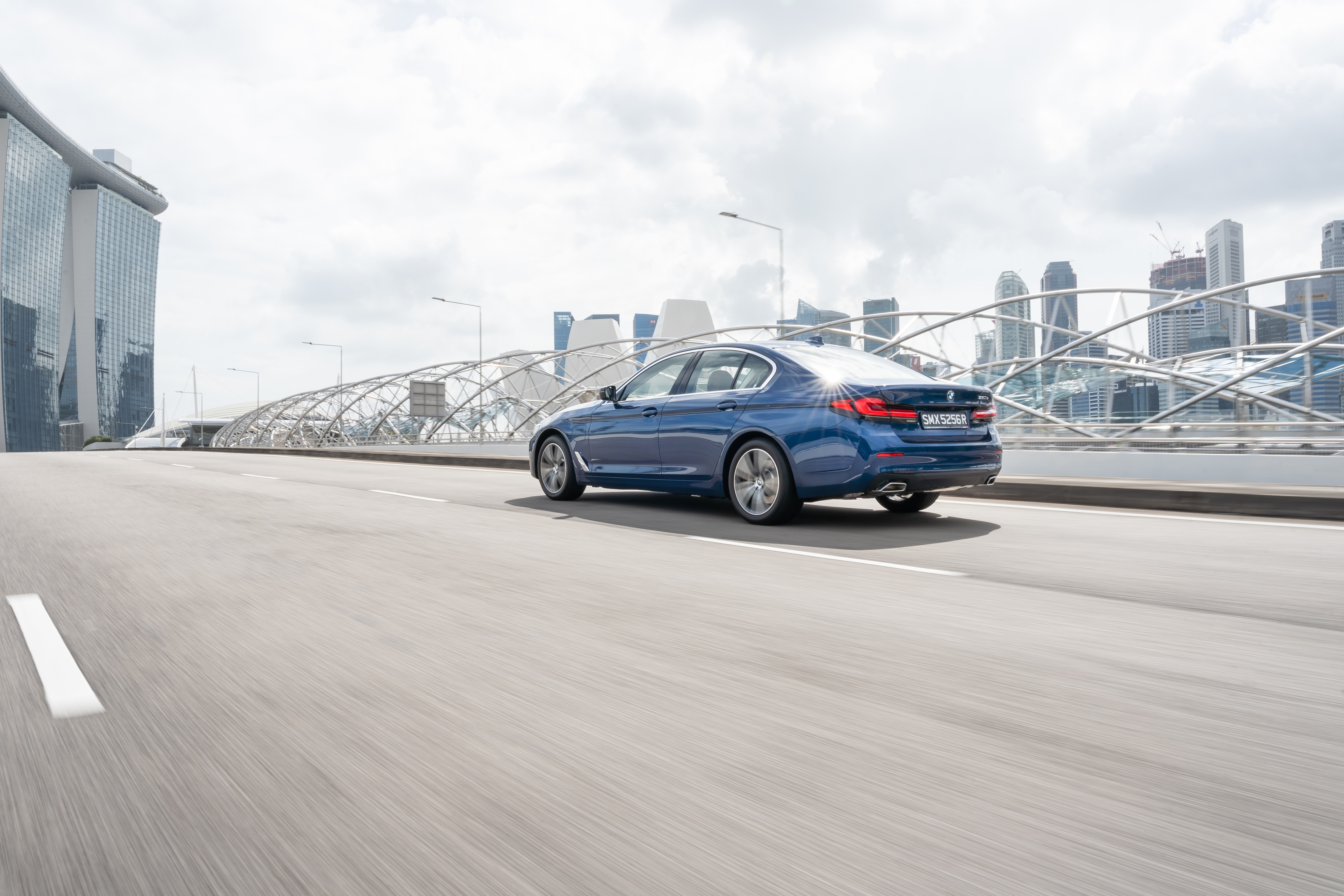 Blue BMW 5 Series 530e Luxury Line on road HD Wallpaper
