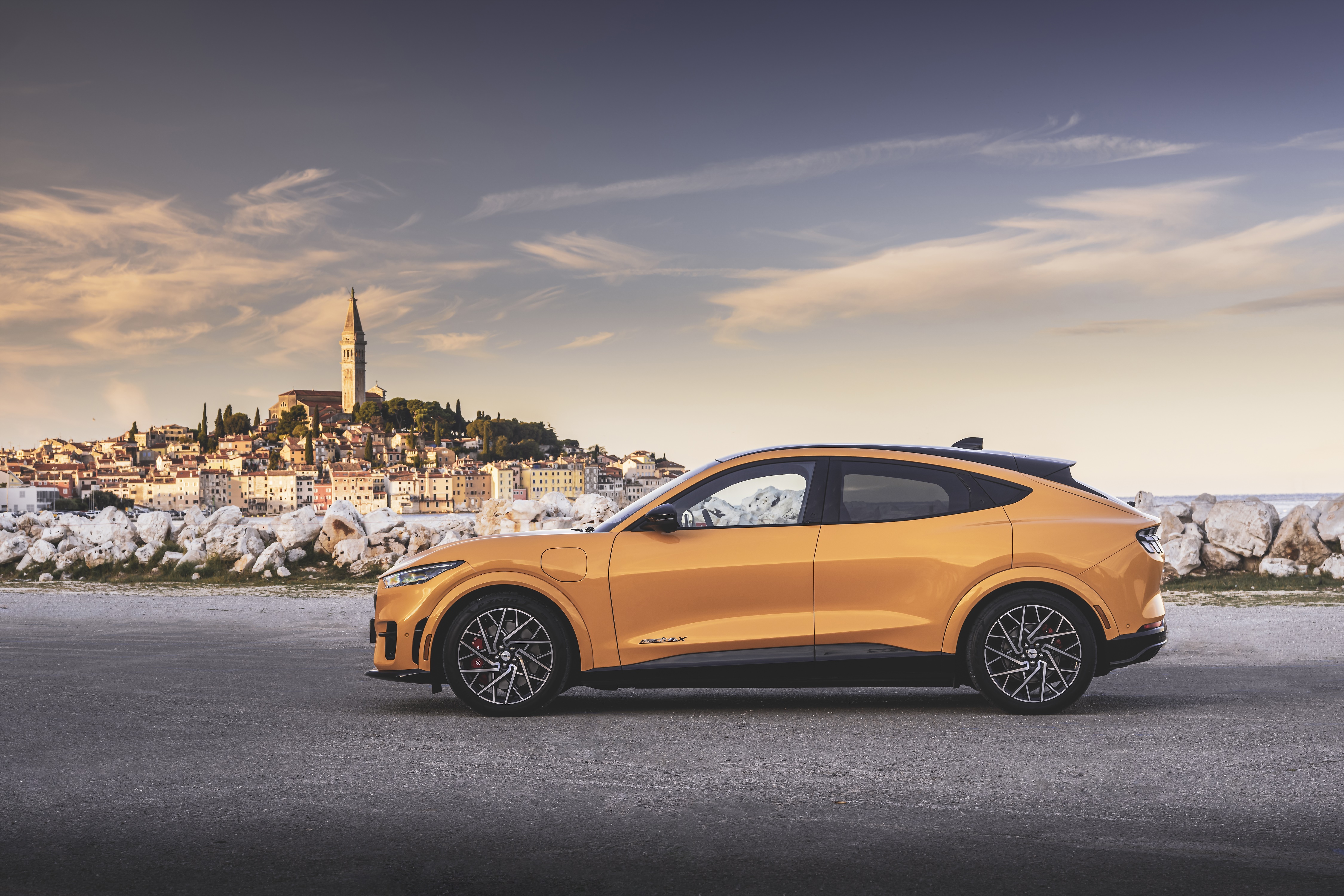 Ford Mustang Mach-E GT parked by a coastal town HD Wallpaper