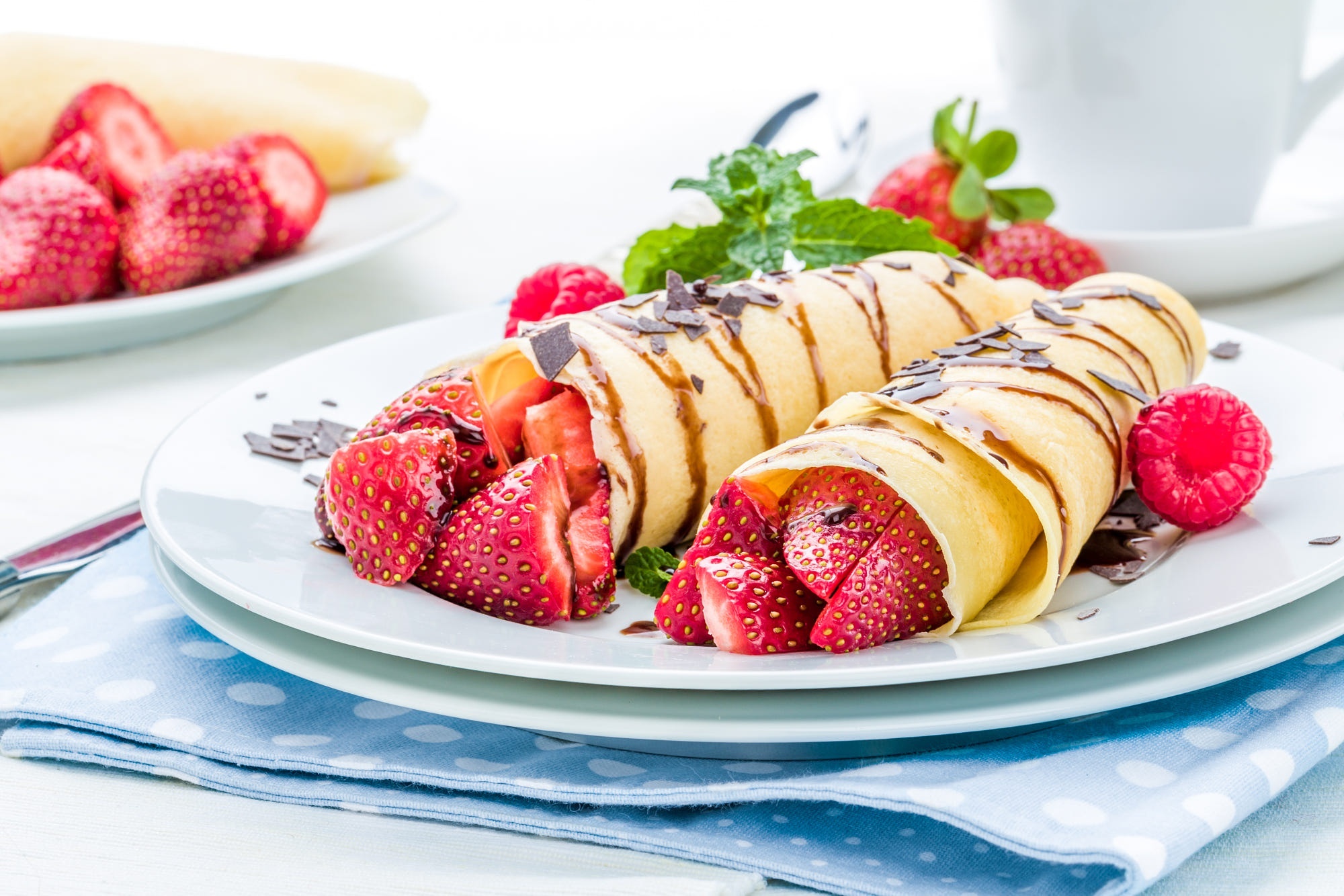Strawberry crepes with chocolate drizzle and raspberries HD Wallpaper