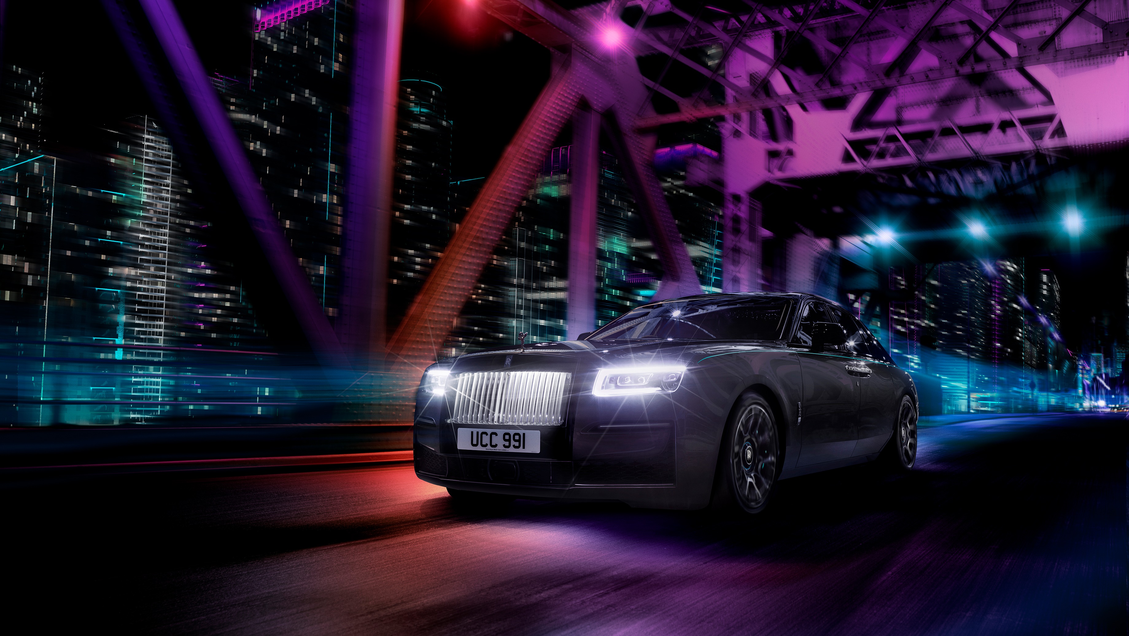 Rolls-Royce Black Badge Ghost driving on a bridge at night HD Wallpaper