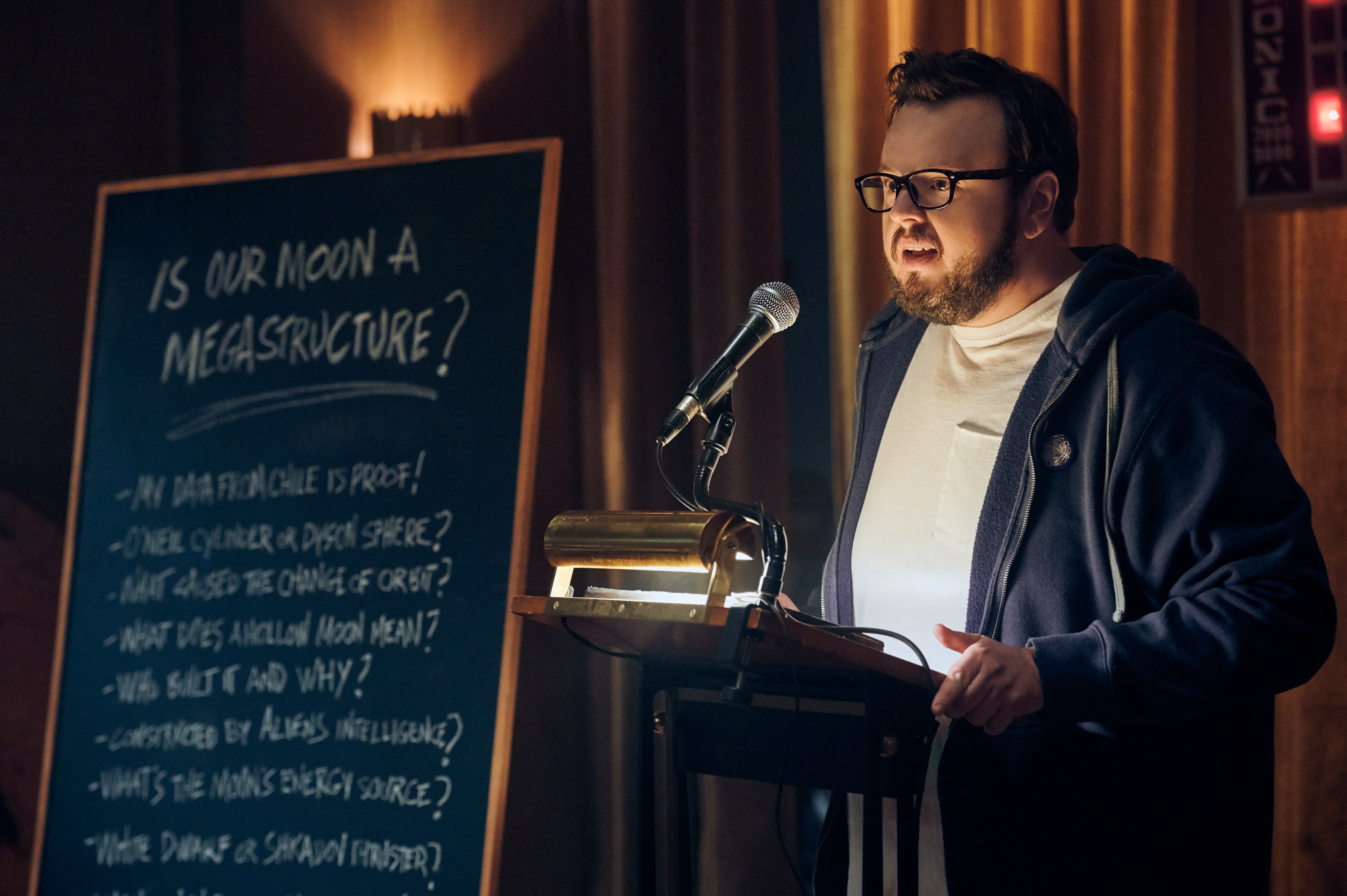 John Bradley presenting at a podium HD Wallpaper