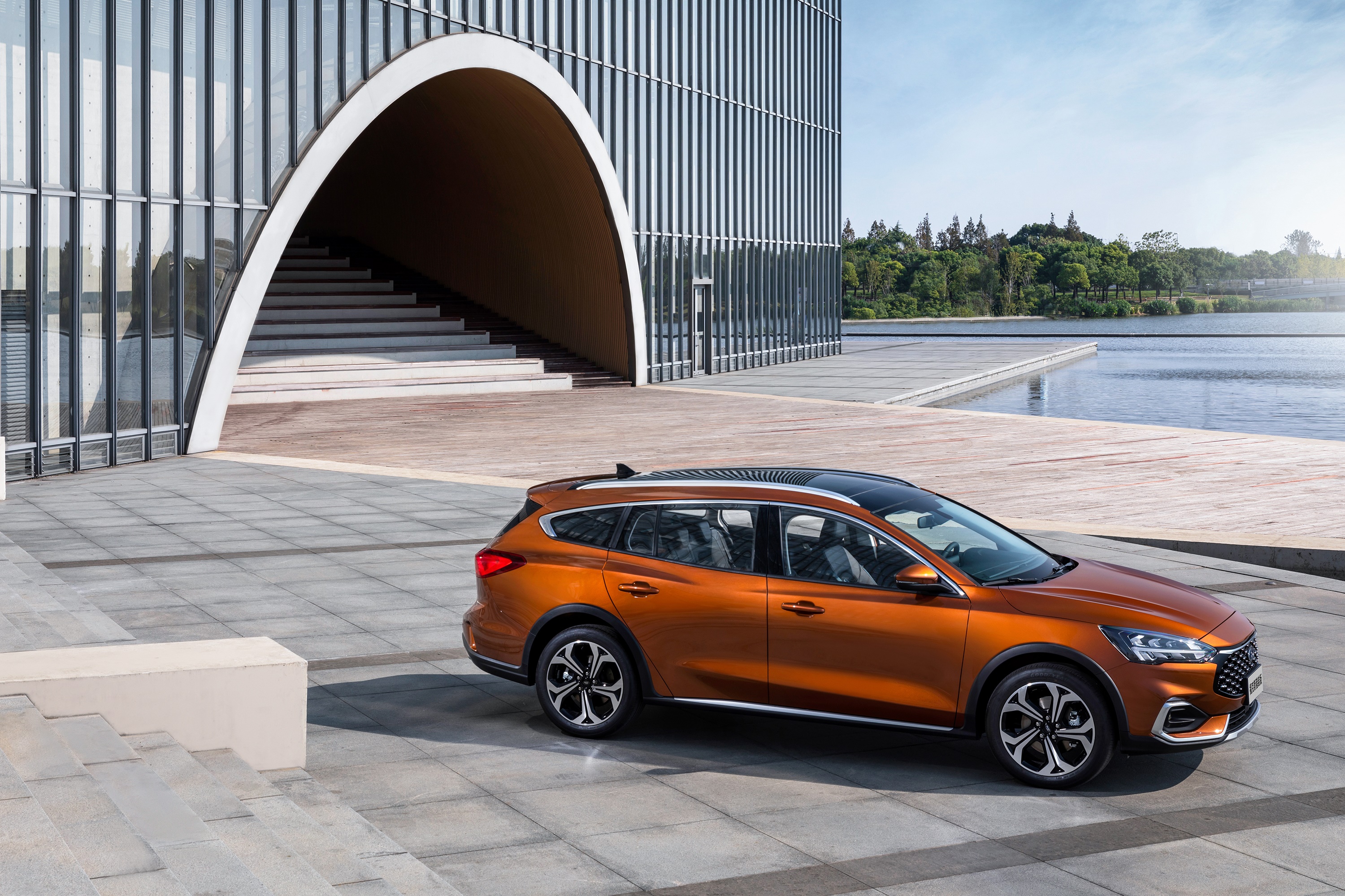 Orange Ford Focus Shooting Brake near modern building HD Wallpaper