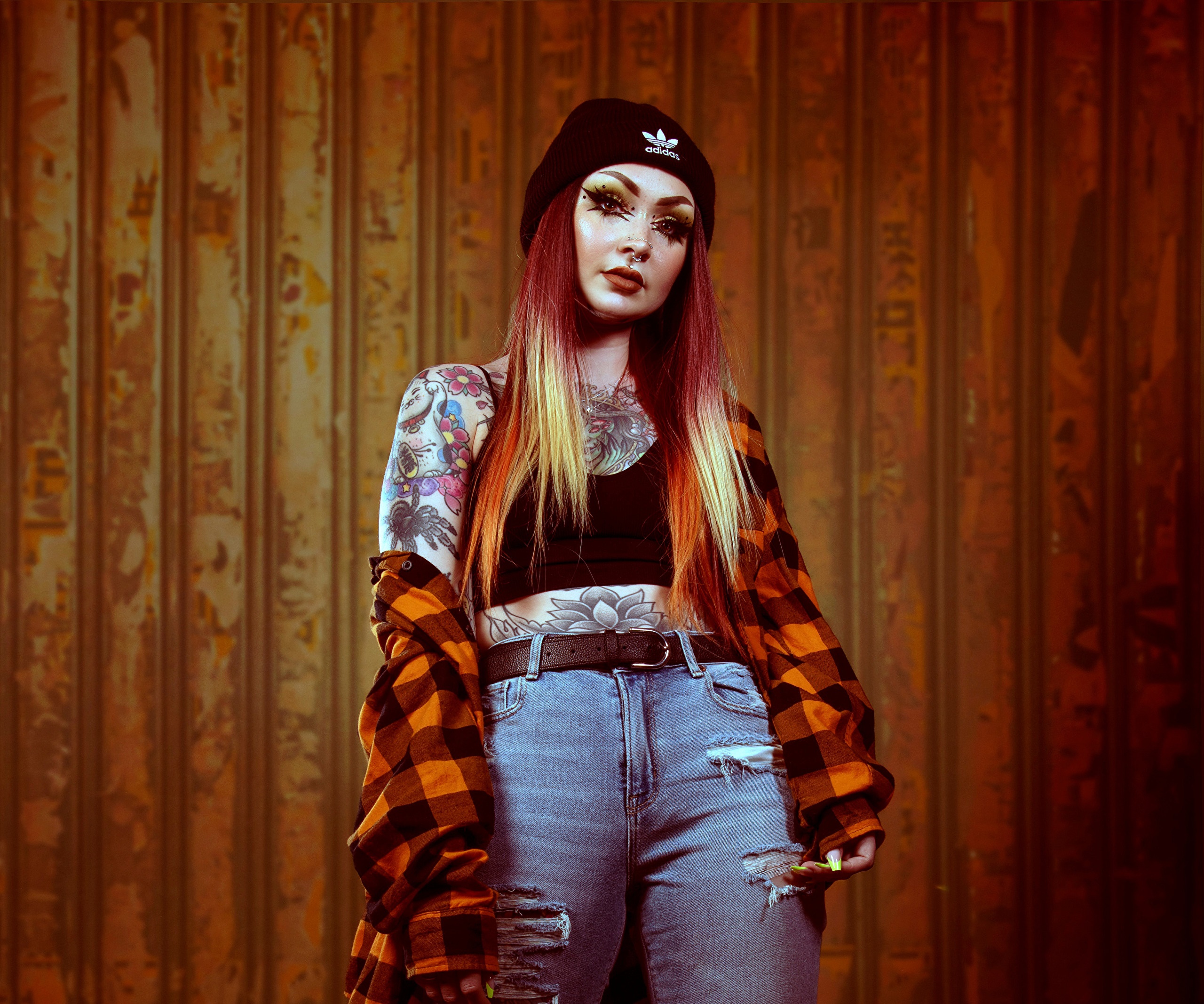 Woman with tattoos wearing a beanie and plaid shirt HD Wallpaper