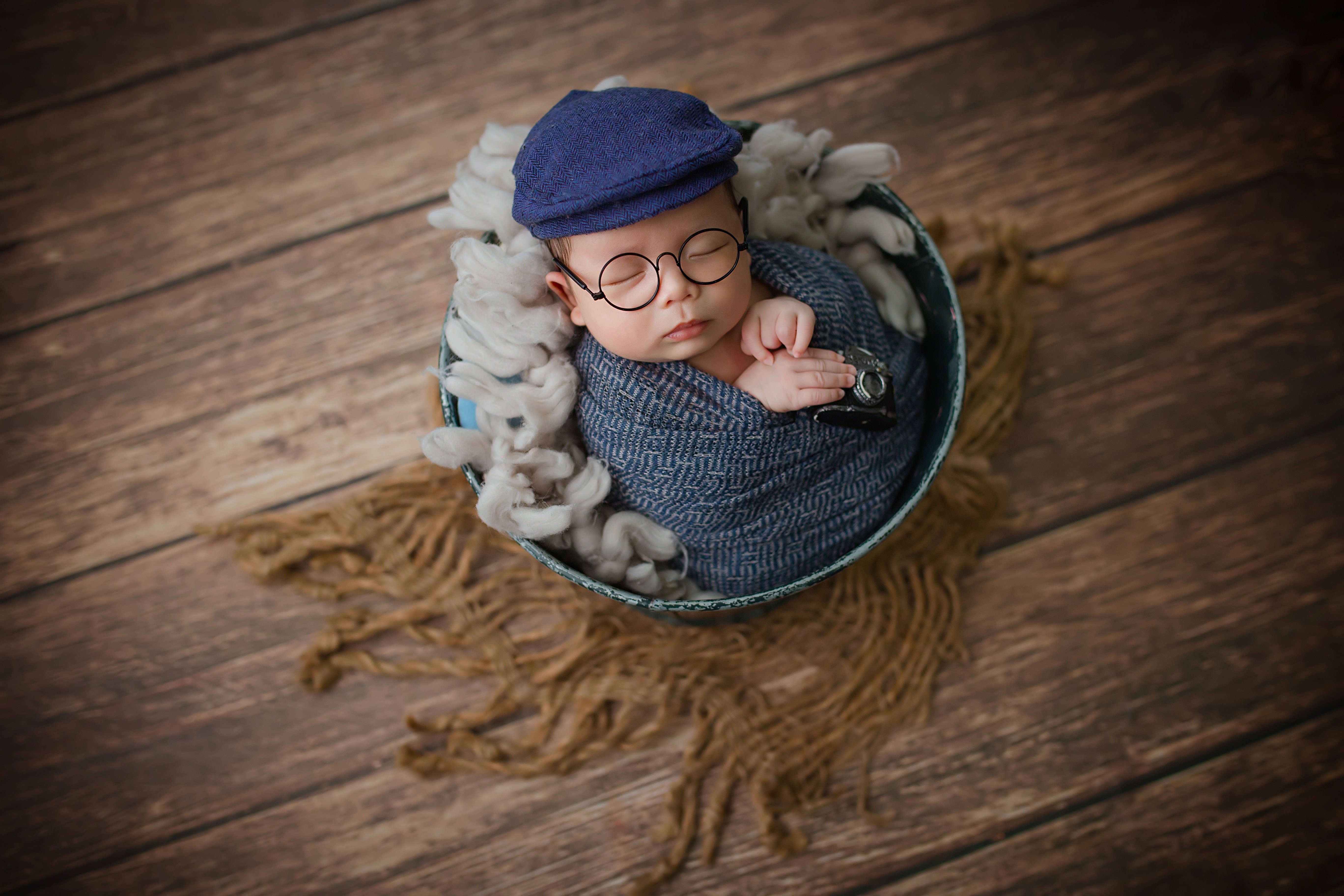 Baby in a basket with glasses and hat HD Wallpaper