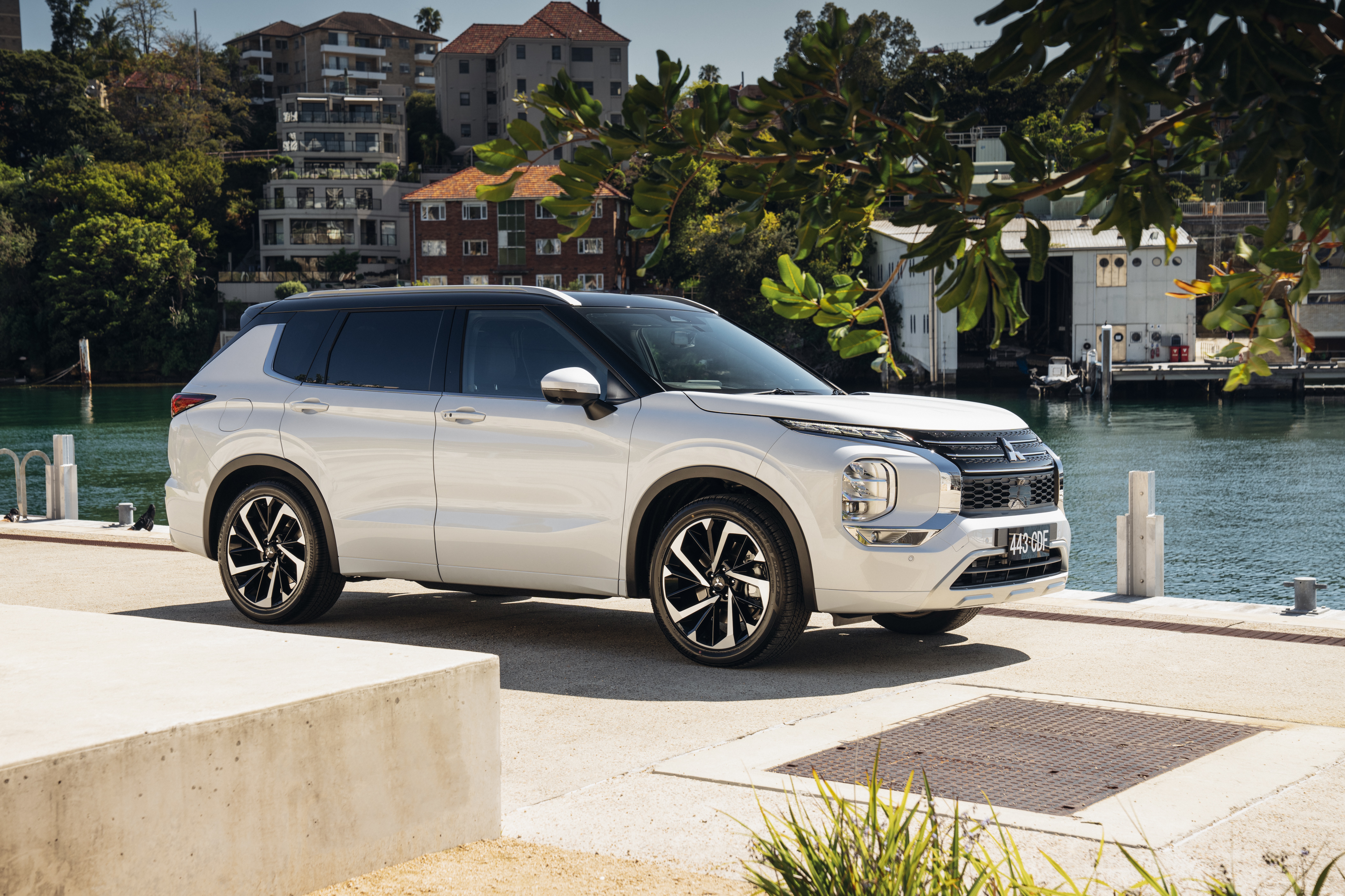 White Mitsubishi Outlander SUV parked by the water HD Wallpaper
